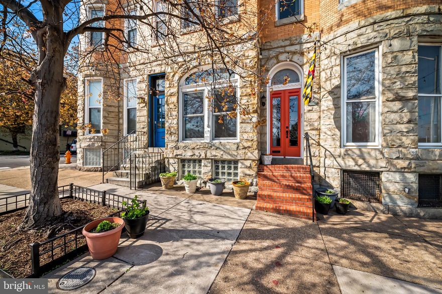 Directly across from Patterson Park, this home’s thoughtful blend of restored historic charm and modern updates shine inside and out. The exterior shows off recently hand-crafted double-hung doors with the original arched transom, a stone and brick facade with a bump-out, and a mix of arched and square windows.  Step through the newly tiled foyer into the living space featuring hardwood floors, updated light fixtures and working transoms throughout. The formal sitting room has pocket doors, large windows facing the park, and a decorative fireplace. A formal dining room flows into the beautifully updated kitchen with an island and plenty of cabinets, blending old-world character with modern style. The original curved staircase featuring both historic and restored molding and a newel post light leads to the second floor, which offers three bedrooms and one bath.  The third floor has another bedroom, a bath, and a bonus room with a small kitchen—perfect for guests. There’s also a walkout to the third-floor roof offering the potential to add a rooftop deck with incredible park and city views. The finished basement adds extra living space, and the enclosed backyard garden is great for relaxing outdoors. The private alley is fenced at both ends, and the home sits right across from Baltimore’s best park.
