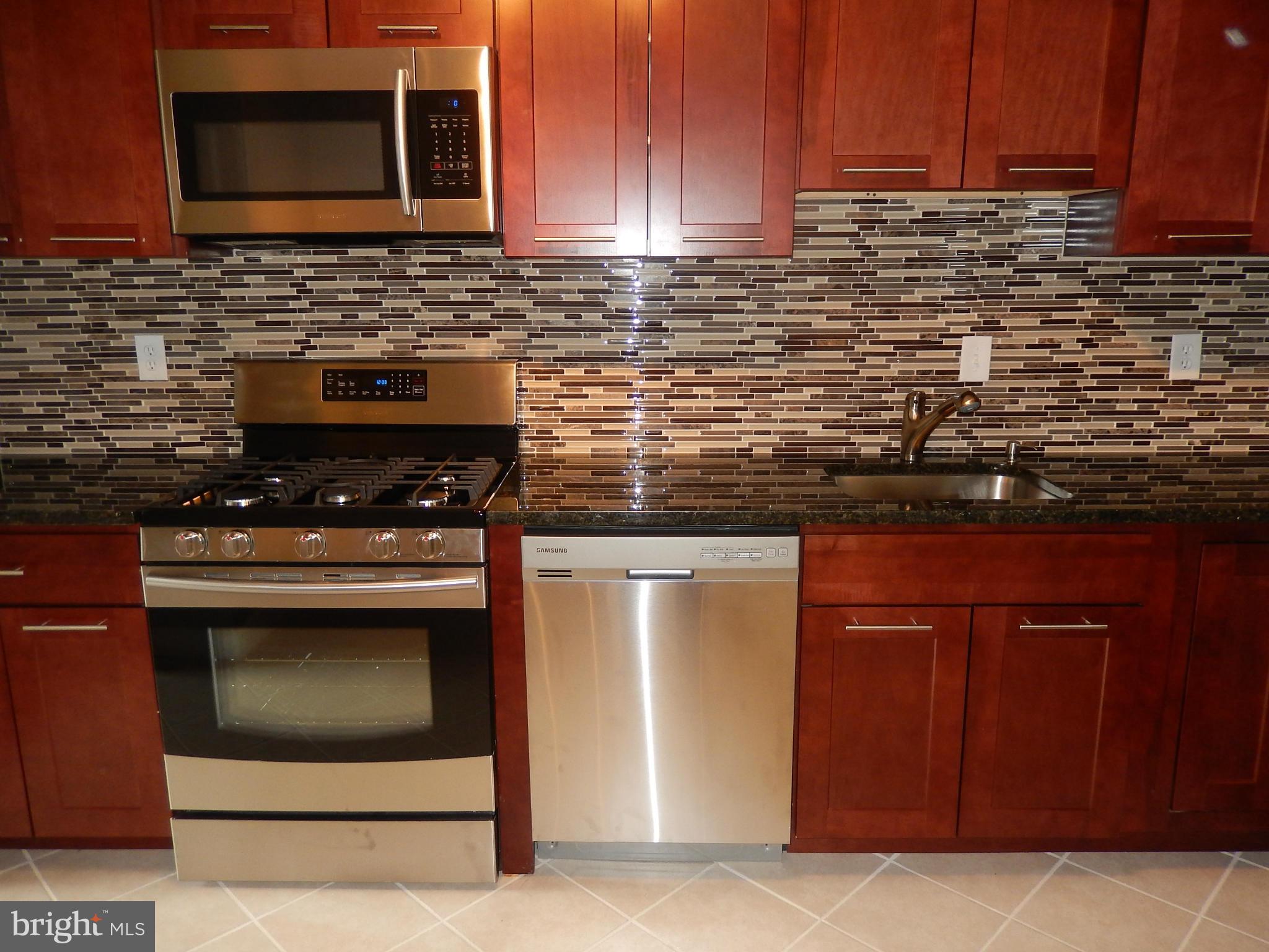 Beautiful full renovation -MUST SEE! Great open floor plan, new kitchen w/ SS appliances & lots of storage space, new carpet, refinished hardwood, tile floor, updated baths, 2 indoor garage spaces available @ $100.00 each per month, lots of outdoor parking. Fantastic location across from the new Pike and Rose Town Center, 1 block from Metro and buses. Pool & T ct. This unit is like brand new!