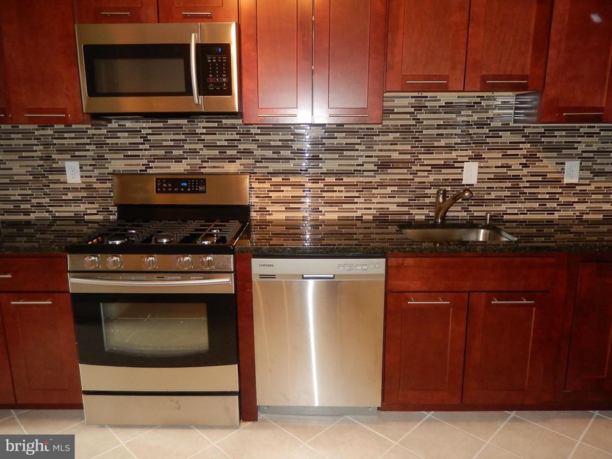 Beautiful full renovation -MUST SEE!  Great open floor plan, new kitchen w/ SS appliances & lots of storage space,  new carpet, refinished hardwood, tile floor, updated baths, 2 indoor garage spaces available @ $100.00 each per month, lots of outdoor parking.  Fantastic location across from the new Pike and Rose Town Center, 1 block from Metro and buses. Pool & T ct.  This unit is like brand new!