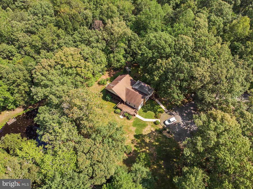 Lovely, custom built home on a large and private 12+ acre lot   so many possibilities for your family to grow and expand   4 bedrooms   2 bathrooms   private, stocked pond   large bay windows   Anderson windows and doors   hardwood and tile flooring   Trane HVAC system   private deck off master bedroom to enjoy the outdoors and view of the water   two sliding doors in master   his and hers closets   enclosed porch off kitchen   mature plantings    4+ garage spaces plus a 30x55ft (approx) steel building   electric and water in two car garage   mature trees and plantings and much more!   Possible subdivisions rights - A must see!