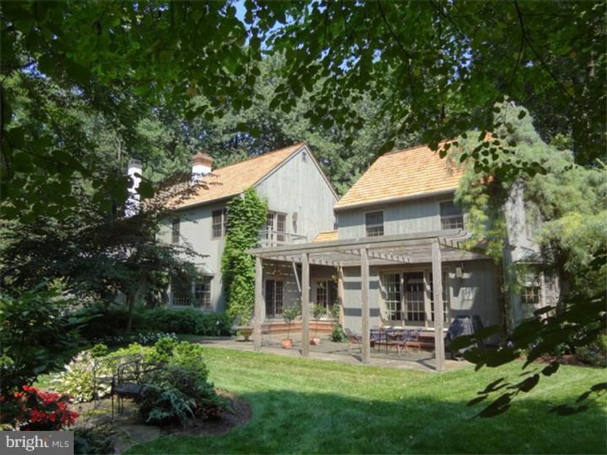 Fabulous compound of main house & two cottages offers many opportunities for the discerning buyer. Set far back from the road on 5 acres of lush landscaping, woods & goldfish stocked pond with waterfall & fountain, it is sophisticated but comfortable living surrounded by nature's beauty and tranquility. Main house has new cedar shake roof, cedar siding, 9' first floor ceilings. Two beautiful additions make it a country retreat of distinction. A wide welcoming hallway, w/two closets, oak floor, has wall of glass doors opening to a bluestone patio & views. To one side is the enormous living room; PR, kitchen & dining room on other. Huge windows & Atrium doors are everywhere. Living room has wall of built-in shelves and cabinetry w/marble wood burning fireplace, crown molding. Bluestone back hall w/closet & doors to 3-car garage & front of house. Galley kitchen has corian counters, oak floor, painted cabinetry w/double crown molding, Sub-Zero refrigerator, Thermador cooktop, GE DW, built-in microwave & wall oven, door to basement. Light filled DR w/window seat set in bay window w/custom millwork, triple Atrium doors to patio. From DR walk up to separate, private bedroom w/Palladium window & bath w/skylight & marble floor. Beautiful staircase in LR takesyou to 2nd floor w/two bedroom suites accessed from a spacious hall w/built-in shelves & cabinetry. One suite has pocket doors, 12' ceilings, enormous closets, maple random width floor, door to balcony & bath w/marble floor, jetted tub, comfort height vanity & skylight. Spacious master BR suite was added in 2000 & is exceptional retreat. Laundry room & access to storage attic, separate HVAC zone, room size walk-in closet, stone hearth gas fireplace w/raised paneling, Palladium window, 10' ceiling, office area w/built-in desk, large balcony w/suspended swing seat & view of woods. Exterior is a marvel of specimen plantings and trees, an arched gate, the pond w/charming sitting area, bluestone patio w/pergola, perennial gardens, deer fencing. Basement has workshop, shelving, plenty of room for storage, W/D & tub sink, Sub-Zero refrigerator. Two 1-BR cottages w/LR, kitchen & bath offer endless possibilities. Guest house, office, separate in-law housing, hideaway, music studio. Detached 2-car garage completes the compound. Extraordinary location, ambiance, value and amenities. Close to New Hope, Doylestown & the best of Bucks. Welcome home!
