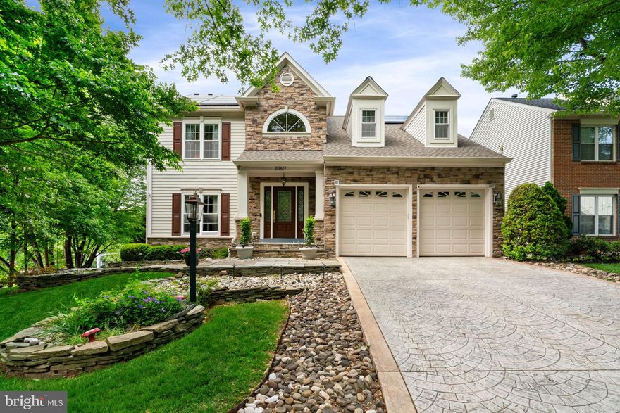 Welcome Home to this absolutely stunning residence in the highly sought-after Cascades community, featuring over $400,000 in upgrades and improvements—truly a must-see!

From the moment you arrive, you’ll notice the impressive curb appeal with a stone front, stamped concrete driveway, Hardie Plank concrete siding, stone walkways, meticulous landscaping, outdoor bar area, gazebo seating area, stone patio, deck, and screened-in porch. This home was designed with entertaining in mind—both inside and out.

Inside, you are welcomed by beautiful hardwood floors, a formal living room, separate dining room, and a fully remodeled kitchen with breakfast bar. Just off the kitchen is the family room with a cozy fireplace, along with a tastefully updated powder room. The sunroom addition is a true highlight, offering a peaceful space to relax while enjoying views of the trees and the incredible backyard entertaining areas.

The upper level features four spacious bedrooms, including a luxurious primary suite with vaulted ceilings, a large walk-in closet, and a fully remodeled spa-style bathroom with heated floors, dual vanities, a separate shower, and a deep soaking tub.

The fully finished walkout basement includes a recreation room, bar area, exercise space, additional powder room, and ample storage. Step outside to unwind under the covered porch, relax on the custom patio next to the outdoor bar, or gather under the gazebo seating area—perfect for hosting friends and family year-round.

The home also features Tesla solar panels and Tesla battery storage, significantly reducing or nearly eliminating your electric bill, with the added benefit of potentially earning credits by selling excess power back to the grid on sunny days.

See a full list of improvements in the document section of the MLS.

Enjoy a walk, jog or bike ride through the extensive trail system that meanders throughout the community and you can find yourself overlooking the Potomac River in Algonkian Park only minutes away. Cascades – The Perfect Community: Living in Potomac Lakes means enjoying the incredible amenities of the Cascades community. Residents have access to two fitness centers, five swimming pools, 15 tennis, pickleball and multipurpose courts, 25 playgrounds, bocce and soccer facilities, and a network of scenic trails winding through Virginia’s beautiful landscapes. Prime Location: Conveniently located near top-rated schools, shopping, dining, and recreational hotspots, this home puts everything you need within reach. Enjoy nearby Algonkian Park, Volcano Island Water Park, golf courses, theatres, the Potomac River, and more! Move-In Ready. Don’t miss your chance to make this exceptional property your forever home. Schedule a private showing today!