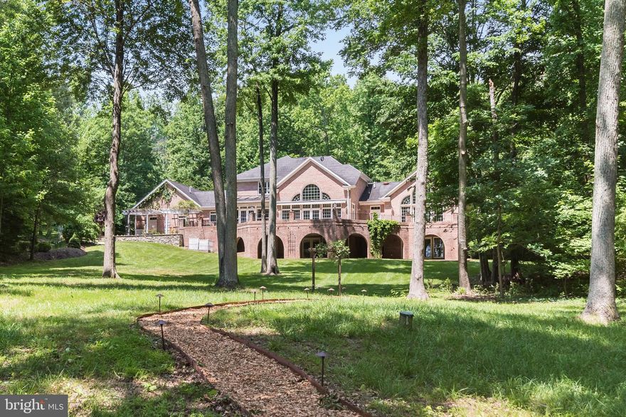 Enjoy peaceful, waterfront living on Old Point Peninsula, an exclusive enclave of 10 homes on 100 pristine wooded acres. Wake up to sunrise views over protected Larkington Cove, where your can keep your boat and be out on the South River in minutes. The home features soaring ceilings and walls of windows; a gracious, open floor plan ideal for entertaining; pristine wood floors with custom inlay; a floor-to-vaulted ceiling stone fireplace; and an expansive deck ideal for taking in views of the grounds, abundant wildlife, and protected cove. With over 8,000 square feet of living space, this home offers main-level living and includes 5 bedrooms, 5.5 baths, an in-law suite with a separate entrance and walk-out patio, and an attached 3-car garage.  A roomy main-level office also could be used as a nursery, den, or sixth bedroom. 

Recent 2024 capital improvements include a new roof and new HVAC systems. ​​​​​​Home also features a whole-house generator; underground watering system; 1000 gallon propane tank (owned); and pier with water, electric, 5000 lb. boat lift,  6' MLW depth. 

Additional photography and full, interactive floor plans will be posted February 28th, and home is available for showings starting February 28th.