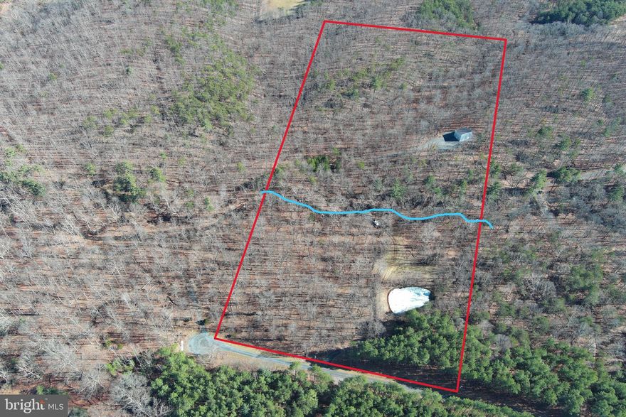 MODERN BARNDO SHELL ON "SAWMILL RUN".....20 ACRES OF PRIVATE PARK LIKE PARADISE....100% USABLE LAND COVERED IN WHITE OAKS WITH SPRING FED POND AND 600+ FT OF "SAWMILL RUN" FLOWING THROUGH THE MIDDLE OF THE PROPERTY. 1000 FT DRIVEWAY LEADS YOU ACROSS THE STREAM TO THE HOME/CAMP SITE ON RIDGE, WITHIN SITE & SOUND OF STREAM. ALL UTILITIES IN PLACE; UNDERGROUND ELECTRIC, WELL & 3 BEDROOM SEPTIC.....READY TO PULL IN & PLUG IN YOUR CAMPER SO YOU HAVE A PLACE TO STAY WHILE FINISHING THE CABIN TO YOUR TASTE. 30X40 STEEL BARNDO/CABIN SHELL WITH POURED FLOOR & PLUMBING IN PLACE. FLOOR PLANS AVAILABLE FOR 3 BED 2 BATH 1.5 STORY LAYOUT......BUT THE BEAUTY OF THIS TYPE OF STRUCTURE IS THAT THE INTERIOR LAYOUT IS ONLY LIMITED BY YOUR IMAGINATION. HOW MUCH WILL IT COST TO FINISH THE INSIDE? DEPENDS ON YOUR TASTE BUT 125K WOULD PROBABLY BE A REALISTIC BUDGET.....DO THE MATH, IF YOU END UP WITH 1500+ SQ FT OF BRAND NEW LIVING SPACE ON 20 STREAM FRONT ACRES FOR 400K......YOU'RE GONNA BE IN AN INCREDIBLE EQUITY POSITION......500K PROBABLY WOULDN'T SNIFF SOMETHING LIKE THAT IN THIS MARKET! EASY ACCESS TOO, ONLY 1/2 MILE OFF THE PAVED ROAD BUT FEELS LIKE YOU'RE 10 MILES IN..... LOCATED IN THE PRESTIGIOUS 10,000 ACRE GATED COMMUNITY ASHTON WOODS, A ONE OF A KIND PLACE, WHERE YOU CAN ESCAPE THE WORK & WORRY OF THE BIG CITY AND TICKLE ALL YOUR OUTDOOR FANCIES....15 MINUTES OFF 4 LANE SUPER HIGHWAY, 10 MINUTES FROM MULTIPLE PUBLIC ACCESS POINTS ON THE SOUTH BRANCH OF THE POTOMAC RIVER, 10 MINUTES FROM MOOREFIELD, 45 MINUTES FROM SKI RESORTS, 10 MINUTES FROM PRIVATE COMMUNITY ACCESS TO NATHANIEL MOUNTAIN WILDLIFE MANAGEMENT AREA 10,000 ACRES OF PUBLIC HUNTING & HIKING.....IF YOU LIKE THE OUTDOORS, YOU'LL NEVER RUN OUT OF THINGS TO DO.....WHO KNEW? ALL OF THIS WITHIN 2 HOURS OF DC.....BELIEVE IT! IF YOU'RE CREATIVE & HANDY.....THIS PLACE IS A SLAM DUNK. THE LAND IS TOP SHELF AND WOULD EASILY FETCH 150K WITH ZERO IMPROVEMENTS. THE INFRASTRUCTURE THAT'S IN PLACE WOULD CONSERVATIVELY COST YOU 60K.....LIKE I SAID, DO THE MATH.....THIS PLACE ADDS UP TO A WINNER EVERY TIME!