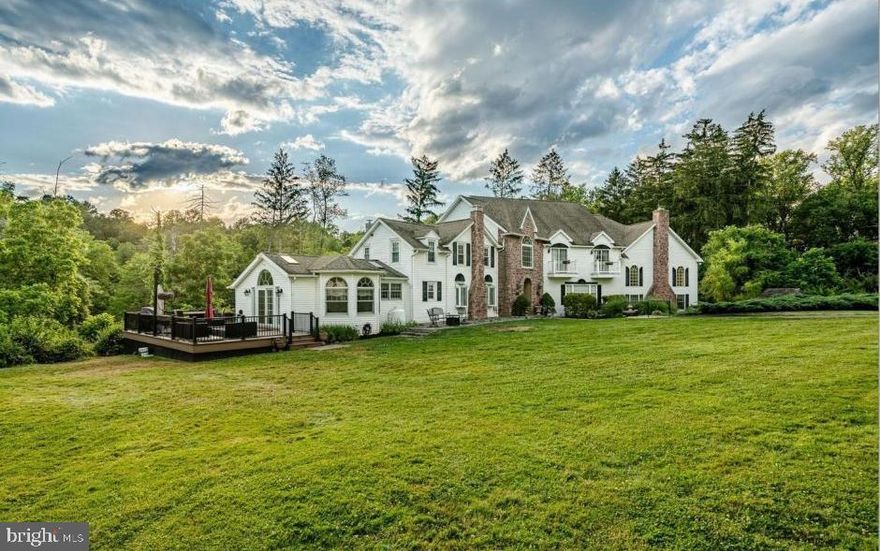 Set along a picturesque, tree-lined driveway, this extensively renovated estate offers a seamless blend of timeless character and modern sophistication. Featuring 6 bedrooms and 4.5 baths, the home is privately situated on nearly 24 breathtaking acres of rolling pastures and tranquil woodlands—providing exceptional seclusion with no HOA and no risk of nearby development encroaching on your space.

A collection of versatile outbuildings—including a barn and a charming cottage—enhances the property’s appeal, making it ideally suited for equestrian pursuits, hobby farming, multigenerational living, or potential income opportunities such as long- or short-term rentals.

Inside, a refined yet highly adaptable layout unfolds, thoughtfully designed to evolve with your lifestyle—offering comfort and functionality through every stage of life. Whether accommodating remote work, multigenerational living, or changing day-to-day needs, the home’s flexible design allows spaces to be reimagined with ease while still providing an elegant setting for both everyday living and entertaining.

The formal living room exudes warmth with exposed beams, gleaming hardwood floors, and a striking stone fireplace with mantel, while a generously sized dining room creates a sophisticated backdrop for gatherings. At the heart of the home, the updated eat-in kitchen features high-end appliances, quartz countertops, a large center island, ceramic tile flooring, custom cabinetry, a pantry, and a beautifully hand-painted ceiling. Large windows, skylights, and sliding doors fill the home with natural light throughout.

The main level offers exceptional versatility, with spaces that can easily shift to meet your needs—featuring a private office, powder room, dedicated theater room, an additional spacious office or flex room, a butler’s kitchen, and a stunning two-story great room. This standout space showcases Brazilian cherry hardwood floors, a dramatic floor-to-ceiling stone fireplace, and expansive windows and French doors that open to multiple porches and decks, creating a seamless indoor-outdoor lifestyle.

Upstairs, generously sized bedrooms provide comfort and privacy, anchored by the luxurious owner’s suite. This serene retreat includes a spacious bedroom, an atrium-style sitting area with balcony access overlooking the picturesque grounds, and a spa-inspired bath complete with a double-sided gas fireplace.


The finished basement further enhances the home’s adaptability, offering flexible space ideal for recreation, fitness, guest quarters, or entertaining, along with an unfinished area that provides ample storage.

Outdoors, the property truly shines with boundless potential. Multiple porches and decks offer peaceful vantage points to enjoy the surrounding landscape, while a separate two-story structure with a two-car garage, livestock stalls, and an unfinished loft provides additional flexibility for a variety of uses.

With its rare combination of natural beauty, refined living spaces, and exceptional versatility, this remarkable estate presents a truly one-of-a-kind opportunity.