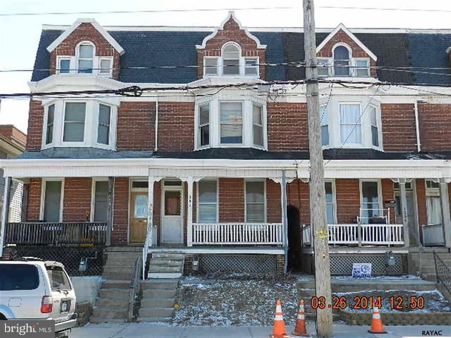 Spacious three story brick home on West end of town. Covered front porch. Fenced yard. Rear balcony porch. Five bedrooms. Kitchen with wood cabinets.