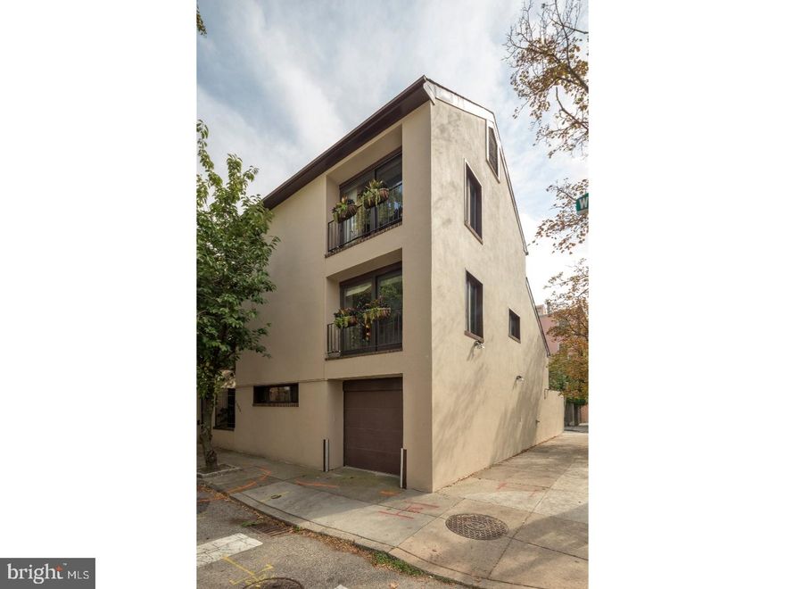 Unique Contemporary corner property on a beautiful tree lined street in the Rittenhouse Square neighborhood with GARAGE parking. Extremely bright with 4 exposures, high ceilings and wood floors and recessed lighting throughout. Wonderful views from all windows.  Enter through gated landscaped garden. Entry foyer . Family room with custom bookshelves. Powder room and double coat closet. Entry to garage. 1/2 flight down to large eat-in country kitchen/dining room , newly redone....6 burner Gas cooking, double wall ovens, dw, trash compactor, Sub-zero refrigerator Extensive custom cabinetry and counter space. Wall of glass doors to brick south facing landscaped garden. Separate storage  room/laundry room and lower level basement. 1/2flight up  from entry ..large bright living room with very high cathedral ceiling. , wood fireplace .Wall of windows overlooking garden. 2nd floor master bedroom with sitting room/dressing room extensive custom closets. Luxurious  split bathroom with tub and double shower. 3rd floor has 2 large bedrooms and full bath.