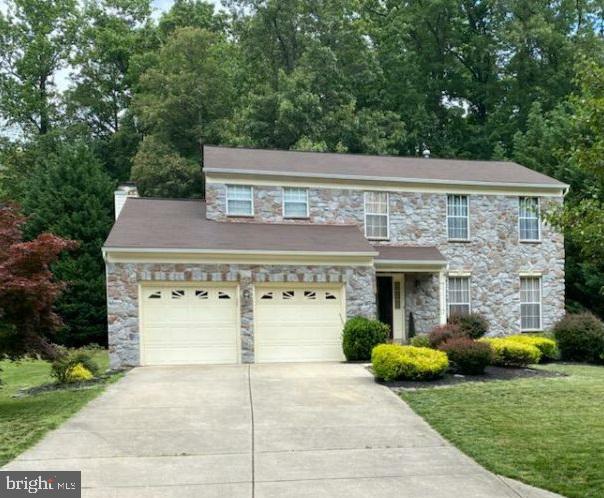 Original Owners have lovingly maintained this home! Over 3000 sq. ft! Numerous upgrades and updates! Stone front & beautiful landscaping greet you. The main level boasts hardwood floors, granite countertops in gourmet kitchen with island cooktop, family room with wood-burning fireplace but electric fireplace in Living Room is excluded. The finished basement has a huge rec room and full bath! Primary BR has hardwood floors and large primary bath with dual vanity with granite top, soaking tub & separate shower. Primary BR electric FP stays. The "Super" 2nd bedroom combines the 3rd & 4th BRs - original closets remain so just add a wall back to get 4 BRs again! As it stands, it makes a fantastic larger BR for family or guests! Nice backyard with deck backs to trees! Small subdivision with NO HOA!