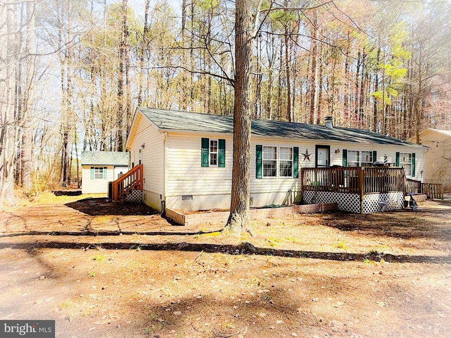 A charming residence featuring three spacious bedrooms and two beautifully remodeled bathrooms. The main bedroom boasts a walk-in closet and an exquisite bathroom complete with a relaxing soaking tub. Enjoy modern living with stainless steel appliances in the kitchen and newer flooring throughout, ensuring a fresh and inviting atmosphere. Embrace the cozy ambiance of the living room, highlighted by a warm wood fireplace, and take advantage of the oversized laundry room, complete with a washer and dryer. With essential updates like a new well pump, roof, and A/C completed in 2018, this home is ready for you to move in and make it your own. The level lot backs to serene woods, providing a peaceful retreat, and features two sheds, including a 10x20 shed equipped with electricity—perfect for a workshop. Accessibility is enhanced with a ramp leading to the front door, making this home suitable for everyone. Conveniently located just 11 miles from PAX River, shopping, and dining, this property is a must-see before it’s gone!