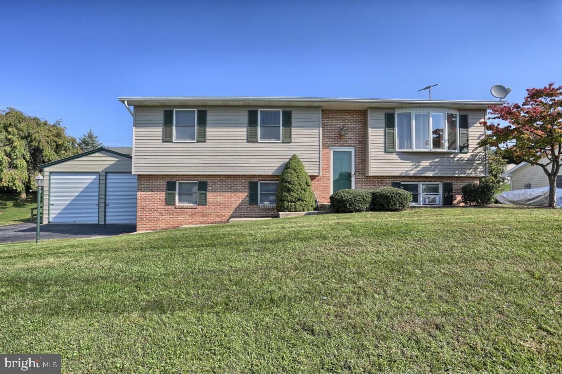 Large well maintained home with lots of features. This house offers 3 bedrooms and 2.5 baths with efficient natural gas heat. Lower level has another room that could be used as bedroom, with full bath on lower level as well. Large Sunroom off of kitchen with separate heat. Large 26ft x 21ft detached garage with lots of possibilities.
