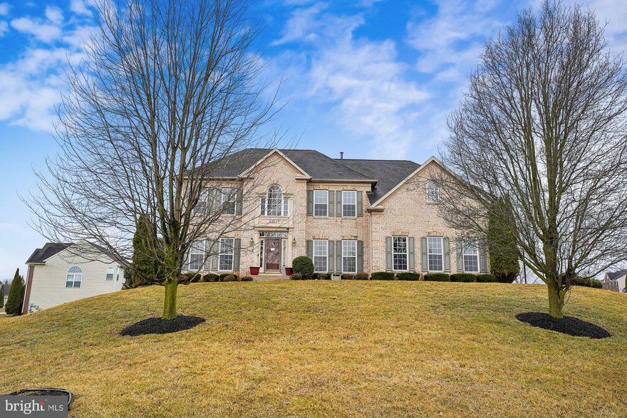 Welcome to 13827 Kialani Drive, nestled in the wonderful Paradise Manor community in Hagerstown. This magnificent home is beautifully maintained and shows exceptionally well. From the moment you step inside, you are welcomed by an open and spacious foyer highlighted by a grand staircase that sets the tone for the elegance throughout the home. The main level offers an elegant dining room and living room, perfect for hosting and special occasions, along with a private library that makes an ideal home office. At the rear of the home, you’ll find a breathtaking, light-filled two-level family room that is both warm and inviting, featuring a cozy gas fireplace—perfect for relaxing on cold winter evenings. The gourmet kitchen is a chef’s delight, offering abundant cabinet space, a large center island, and beautiful granite countertops. Just off the kitchen, a bright and airy sunroom creates a wonderful gathering space and leads out to the deck, making it perfect for entertaining or simply enjoying a peaceful view. Upstairs, the spacious primary suite offers a peaceful retreat with a lovely sitting room, a luxurious primary bathroom featuring a centered jetted tub, dual sinks, and two large walk-in closets. This level also includes three additional generously sized bedrooms and two full bathrooms, providing comfort and space for everyone. The fully finished basement expands your living space with a huge recreation room, a fourth full bathroom, and a large den that can easily be transformed into a playroom, exercise room, media room, or whatever suits your lifestyle. Beyond the stunning interior, this property features a side-entry two-car garage and sits atop a hill on a beautiful corner lot of 0.69 acres, offering a sense of privacy, tranquility, and plenty of outdoor space to enjoy throughout every season. Come experience all that this exceptional home has to offer—you will not be disappointed.