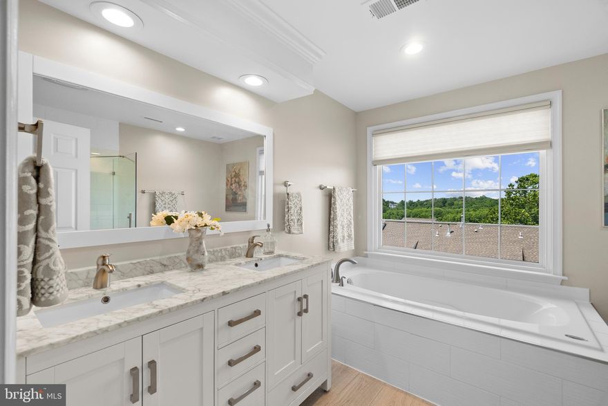 Please enjoy this 3 bed, 2 full & 2 half bath, 2-car garage, 2220 finished sqft TH in the Overlook community located at Alexandria’s West End. The quality & scope of the upgrades throughout the house present a rarely found opportunity: A truly move-in ready home located inside the Beltway with immediate access to 395/495/95, but also within a tree-lined, green-space community surrounding a Fairfax County Park. Overlook is also well positioned for residents to reap “Livability” and house valuation benefits from the forthcoming WestEnd Alexandria development project (formerly Landmark Mall). To learn about Overlook and West End Alexandria, ask your agent for the URLs for the branded version of the virtual tour (for Community & living in West End Alexandria videos).and the Listing Agent's website on Overlook, which is a comprehensive visual and information website on choosing this Community as your Home. These websites include a Community video with spectacular aerial views and videos/info on restaurants, shopping, and other "Livability" benefits from proximity to everything, including the WestEnd Alexandria project with the new Inova Alexandria Hospital Campus.

House Details:  A focus on the details – both big and small – is apparent throughout the house, from the 12-foot ceiling and two walls of windows with Plantation shutters in the Living Room and adjacent Sunroom, to the upgraded light fixtures, to the Satin nickel hardware on every door in the house, with levers replacing knobs for a more elegant look and feel. An eye-pleasing color palette throughout the house will complement any design style preferred by the new homeowner. The house opens to an entry hallway with steps up to the Living Room and Sunroom on the Main Level. The 12-foot ceiling and the wall of floor-to-ceiling windows provide a feeling of openness and natural light throughout the Main Level. The Living Room has a gas fireplace with flanking built-ins as a design focal point. The Sunroom has two  walls of windows, with access via a replaced slider door to the composite deck with private view from the mature Crepe myrtle trees behind the house. 

The LR leads to the elevated Dining Room and kitchen. The kitchen has stainless appliances, an L-shaped Corian counter with space for two stools, and a tile backsplash. The kitchen is sized to allow for a table in front of the bay window and a separate seating area. A fully remodeled half bath is located on the Main Level. The Owner’s Suite is large enough to make a King-size bed look small, with a walk-in closet and separate seating area. The Owner’s Suite Bathroom is fully remodeled with a granite topped, dual sink, footed vanity, custom tile on floor, shower, and tub surround, frameless glass shower door, and nickel sink, tub, and shower fixtures. The 2nd spare bedroom is sized for a Queen bed with a double door closet. The 3rd bedroom is currently furnished as an office, with a double door closet. The fully remodeled 2nd full bathroom upstairs serves the 2nd & 3rd bedrooms. The laundry is located on the bedroom level. The bedroom level has newly installed carpet throughout. The Lower Level has a gas fireplace with flanking built-in bookcases and carpeted floor, with room to watch a TV mounted above the fireplace. The new homeowner can also set up a library or office in the bump out area, which has two walls of windows. The lower level has direct access via a replaced slider door to the composite lower wraparound deck. The Lower Level also has an upgraded half bathroom (vanity & tile). The garage is a two-car, single door model. The driveway offers space for two parking spaces. Visitor parking is available four houses away, as well as either end of Split Creek. The AC system was replaced in 2018 (furnace is 2010). The roof was replaced in 2018. Triple pane replacement windows installed in 2021. Water heater was replaced in 2017.  Driveway power washed & windows cleaned (June 14 after photo shoot).