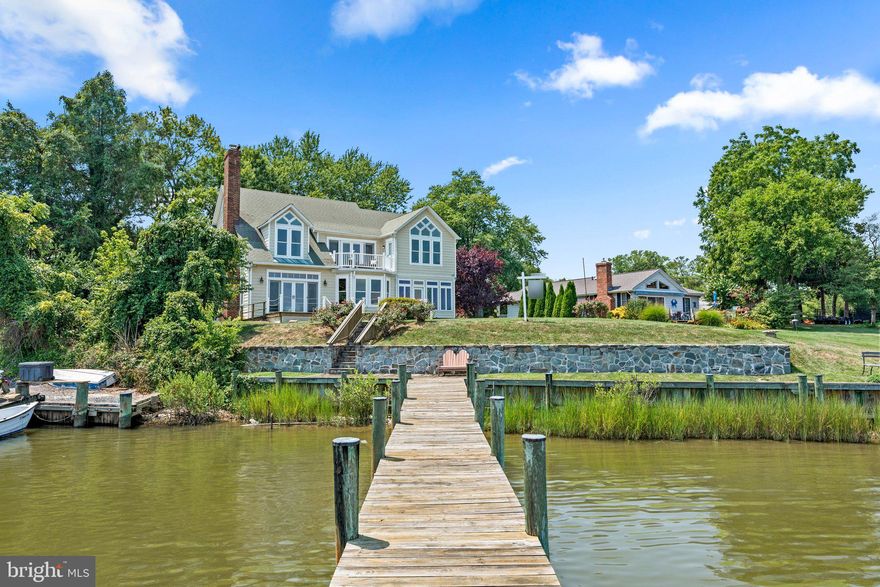 MOTIVATED SELLERS PRICE REDUCED 100K Experience serene waterfront living in this stunning 5-bedroom, 3.5-bath home. Located on the West River with private dock, bulkheaded pier, and boatlift, accessing the Chesapeake Bay will be a breeze! This home is nestled within the desired community of Galesville with small town feel, and walkability to restaurants, shops, and community pier. Move-in ready, the home is filled with natural light and boasts hardwood floors, dual primary suites, eat-in kitchen, sunroom, cozy family room with fireplace, and dual-zone geothermal heating/cooling. The upper-level primary suite includes walk-in closets and an en-suite bath with double vanities. Enjoy breathtaking views from the main and second-floor decks, surrounded by mature landscaping. The two-story detached garage offers ample storage and an unfinished second-floor space. The deck has been recently resurfaced. Property is zoned W2, which holds the potential for a commercial or home-based business! Mean Low Water approximately 4' deep. Don't miss out—this home is a gem!