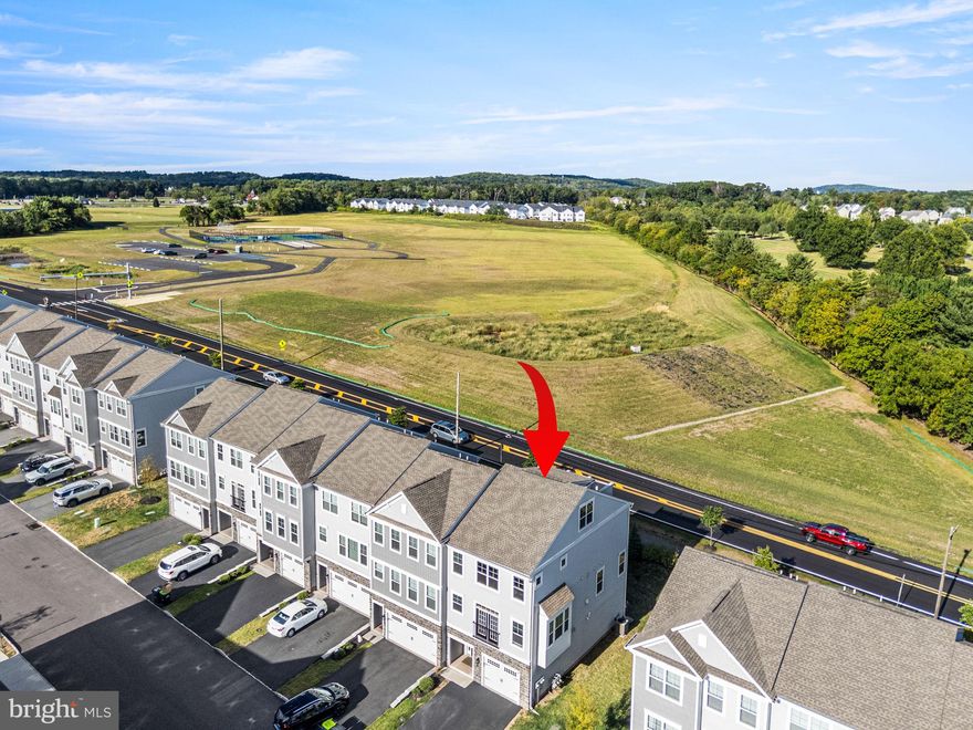 Seller ready to pay up to $5000 towards the closing cost. Welcome to 164 Larrabee Way, this exceptional Warwick Model (Largest in the community) end-unit townhome offers a truly rare setting, located in the only row of homes with unobstructed views of Limerick Community Park, providing scenic vistas and a level of privacy unmatched within the community. The home’s east-west exposure fills the space with abundant natural light throughout the day, from bright mornings to warm evening sunsets.

Built in 2021, this nearly new home blends contemporary design with thoughtful functionality across multiple levels. Upon entry, an elegant oak staircase with American Craftsman posts and white square balusters leads to the main living area. The open-concept main level features engineered oak hardwood flooring and warm, neutral tones, seamlessly connecting the living room, dining area, and kitchen—ideal for both everyday living and entertaining. The dining area is enhanced by a bay window, adding character and additional natural light.

The living space includes a separate coffee bar with cabinetry, creating a perfect everyday convenience. The kitchen showcases 42" cabinetry with crown molding, granite countertops, and an impressive 8-foot island with seating, ideal for casual dining and gatherings. Sliding doors lead to the deck overlooking the park, while the covered patio below the deck remains dry during rain, offering year-round outdoor usability.

What truly sets this home apart is the private rooftop deck, a feature found in only one home in this entire row. Designed for entertaining and relaxing, this rooftop retreat is paired with an adjacent flex room with storage and a separate HVAC system, offering incredible versatility. This space can function as a 4th bedroom, guest suite, home office, media room, or fitness room—an extremely rare and valuable option.

The second floor features a spacious primary suite with a cathedral ceiling, walk-in closet, and a spa-like en-suite bath with a double-bowl vanity, ceramic tile flooring, and a large shower with ceiling-height subway tile and a built-in bench. Two additional bedrooms, a full hall bath, and a convenient second-floor laundry complete this level.

The finished lower level provides additional flexible living space with access to a ground-level patio, making it ideal for a media room or family room.

The attached one-car garage offers everyday convenience and includes built-in overhead storage. Additional upgrades include a whole-house humidifier, air purifier/filtration system, and water softener. Both HVAC systems are equipped with Honeywell media air cleaners—Honeywell 200 for the main furnace and Honeywell 100 for the attic heat pump—providing enhanced air quality and comfort.

Located in the highly regarded Spring-Ford School District, this home offers easy access to Route 422 and major roadways and is approximately 20 minutes from King of Prussia for premier shopping and dining. Community access leads directly to 70 acres of parkland with trails, courts, playgrounds, and recreational amenities. 

Welcome home — and make it your own. Showing starts on Saturday, Feb 28, 2026 - Open House  11AM - 1PM