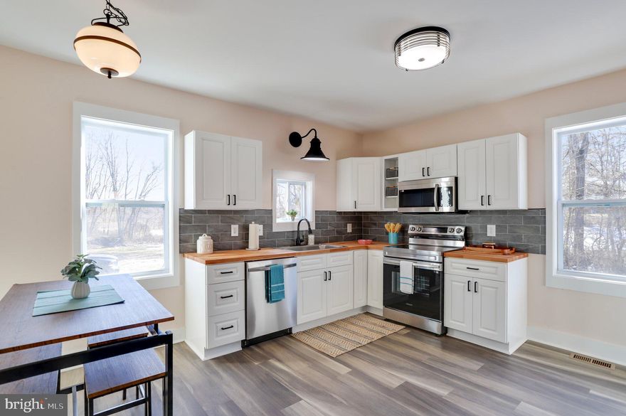 PRICE REDUCTION! Sellers will pay $5000 toward buyer's closing costs. Unique property in Jefferson County! Fully renovated 1900's Sears Roebuck Farmhouse situated on almost an acre (.97) of unrestricted land at townhouse price! Bring the chickens, ATV's, gardening gloves, etc! The large, level backyard is where the kids and pets can run! Behind the property is an apple orchard for more exploring and fun.  Once inside, you will find the most beautiful black and white staircase and luxury vinyl plank flooring throughout. The main level consists of a primary bedroom and bathroom, or that room can be a living room. There is another room that could be a family room or dining room.  Every room in the home is large! The beautiful, country eat-in kitchen has stainless steel appliances and butcher block countertops. There is a powder room, mudroom, and laundry area with a washer/dryer combination. Upstairs are 2 very large bedrooms and very large bathroom with a tub/shower. One of the upstairs bedrooms has a walk-in closet. One of the nicest features of this home is the amount of natural light that flows throughout. The back of the home contains two concrete patios for entertaining.  There is a shed/small detached garage to store mowers and toys. All new plumbing and electrical updates. Two zone HVAC. Located very close to Route 9 bypass, the bike trail, Shepherdstown, schools, and shopping. You really need to see this home to appreciate an oldie but goodie; the work has been done for you! Septic was inspected and pumped 2/24.