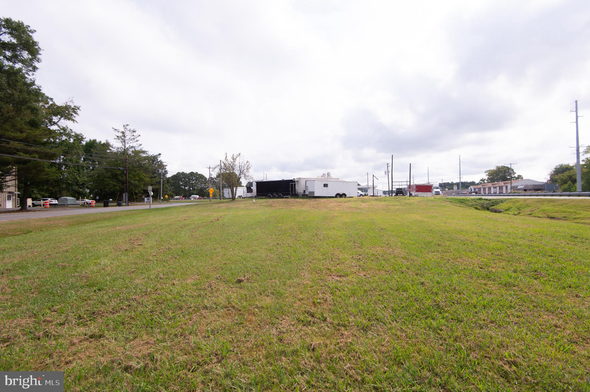 Commercial property on Rt. 50 intersection. Two concrete block and frame buildings totaling 4,350 +/- square feet - great for retail or commercial space. .72 +/- acres with 2 highway cuts on west bound RT. 50 plus rear entrances from Old Rt. 50. Located right next door to the Hyatt Regency Chesapeake Bay Spa and Golf Resort. The Bucktown light provides easy access for east or west bound Rt. 50. Estimated that 34,000 cars pass here daily - 30 MPH speed zone.
First building features vaulted high ceilings, bath, office area. Rear building has garage door entrances on Old Rt. 50 with expandable second floor 32 x 36.