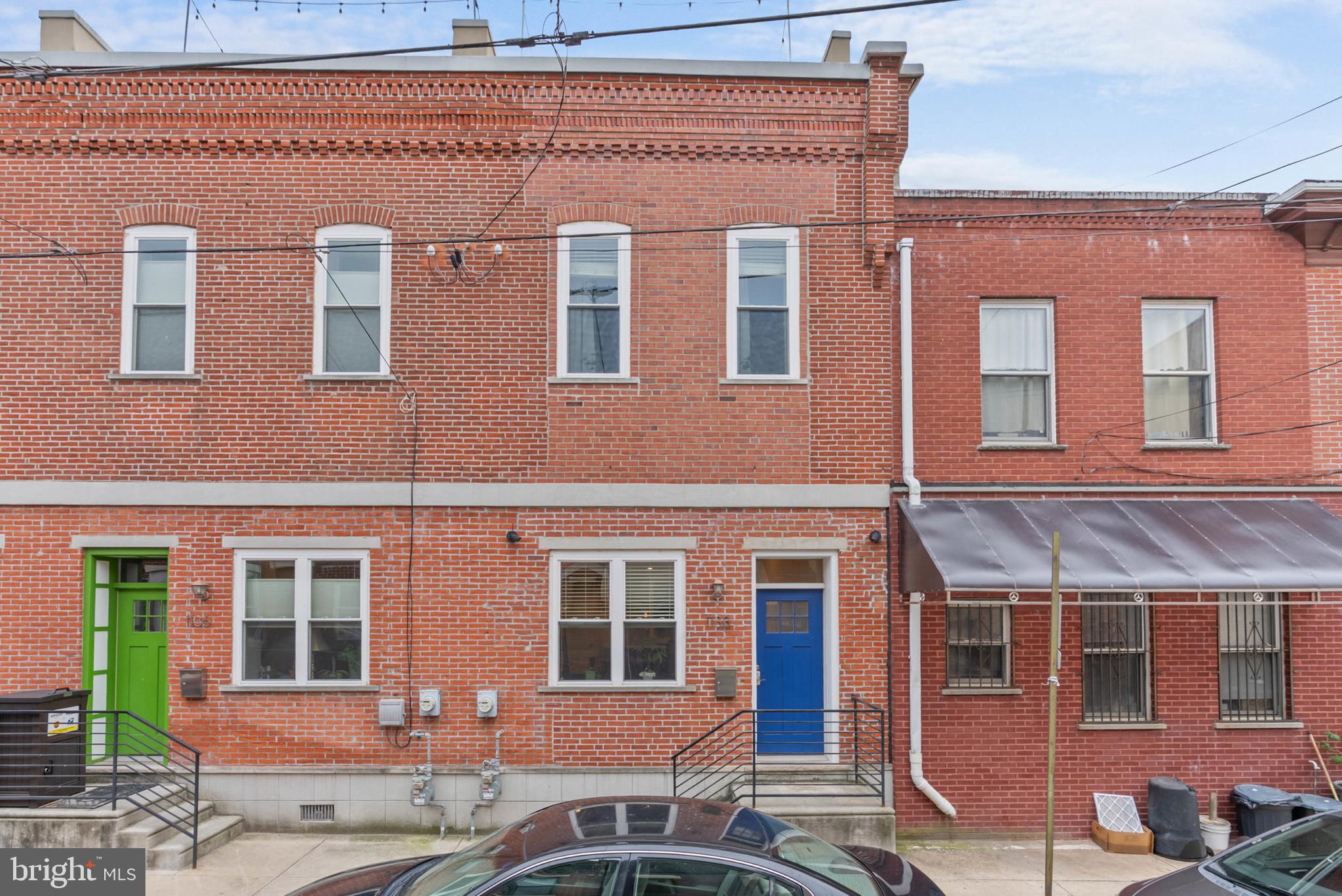 Nestled on a quiet block in Philly's sought-after East Passyunk neighborhood, 1138 Emily St is a modern, 3-bed, 2.5-bath, 2-story home with a spectacular roof deck. The front exterior features a classic red brick facade and elevated entry. Inside, soaring ceilings and gleaming hardwood floors frame the bright, open, and airy main level. There's plenty of space to create separate living and dining areas for entertaining, plus a convenient powder room is tucked in the corner. The gourmet kitchen is fitted with 42" shaker cabinetry, granite counters, stainless steel appliances, including a Viking range, a unique graffiti-style tile backsplash, a breakfast bar, and a hidden pantry. At the rear is a bedroom with double closets. Up on the second level, the spacious, sunlit primary suite at the front boasts more high ceilings, a custom closet, and an attached bathroom with a glass-enclosed shower. Down the hall is the laundry closet, a coat closet, the second full bathroom, and the third bedroom. Topping off the home is an expansive roof deck with tons of space to entertain while admiring views of the Center City skyline and Citizens Bank Park. A large crawl space off the top staircase provides extra storage, and the home's utilities include central a/c, gas heat, and electric hot water. In addition to everything inside, this fantastic location earns a Walk Score of 94! Steps away, East Passyunk Ave is lined with top-rated restaurants, unique shops, and lively entertainment. A few blocks south, the Bok Building is an old school turned community workplace hosting diverse small businesses, including a preschool, a dog daycare, art galleries, non-profits, eateries, and a rooftop lounge. Target, ACME, IKEA, and Lowe's are a short ride away, plus there's easy access to public transportation, Broad St, the Sports Complex, I-76, I-95, and South Jersey. Schedule your tour today!