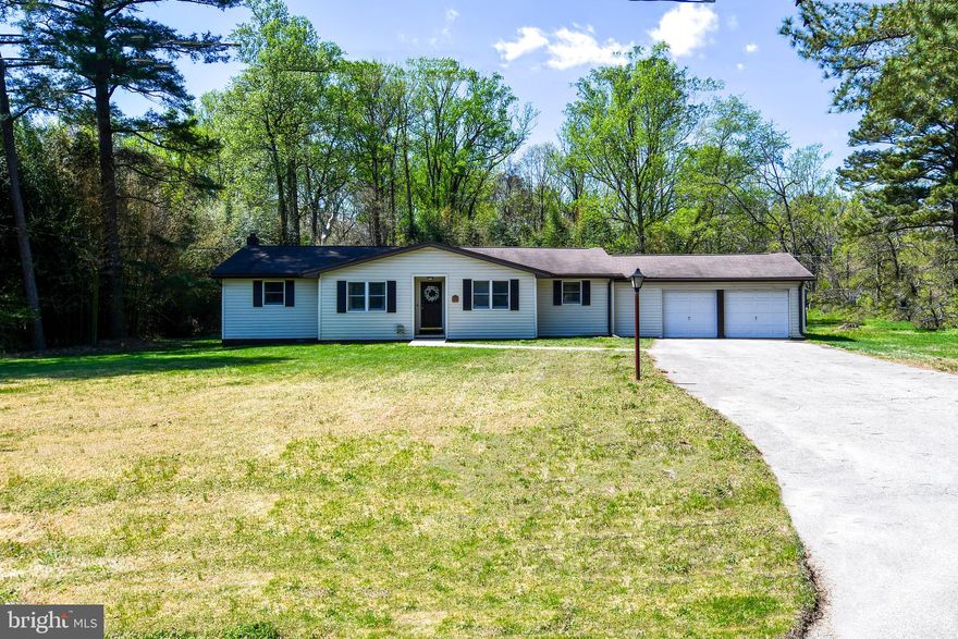 Must See! 3 Bedroom 1.5 Bath Rancher totaling 1,412 sq ft Sits on .87 acre lot. Freshly Painted throughout! Front Entrance into Living Room w/ Hardwood flooring! Huge Kitchen with Island and updated Cabinets.  Built- in Table and Bench w/ storage.  Double Ovens and Stove top.  New  SS Refridgerator! Family Room off Kitchen w/ door access to Exterior Rear Deck! Powder Room and Laundry Room has Utility sink and Cedar Closet.  Primary Bedroom has lighted ceiling fan and hardwood flooring.  2 additional Bedrooms w/ lighted ceiling fans and new carpet.  Hallway Bathroom has walk in shower.  Attached 2 Car Garage w/ Bonus Storage Room and Detached  Workshop w/ electricity, sink and urinal!