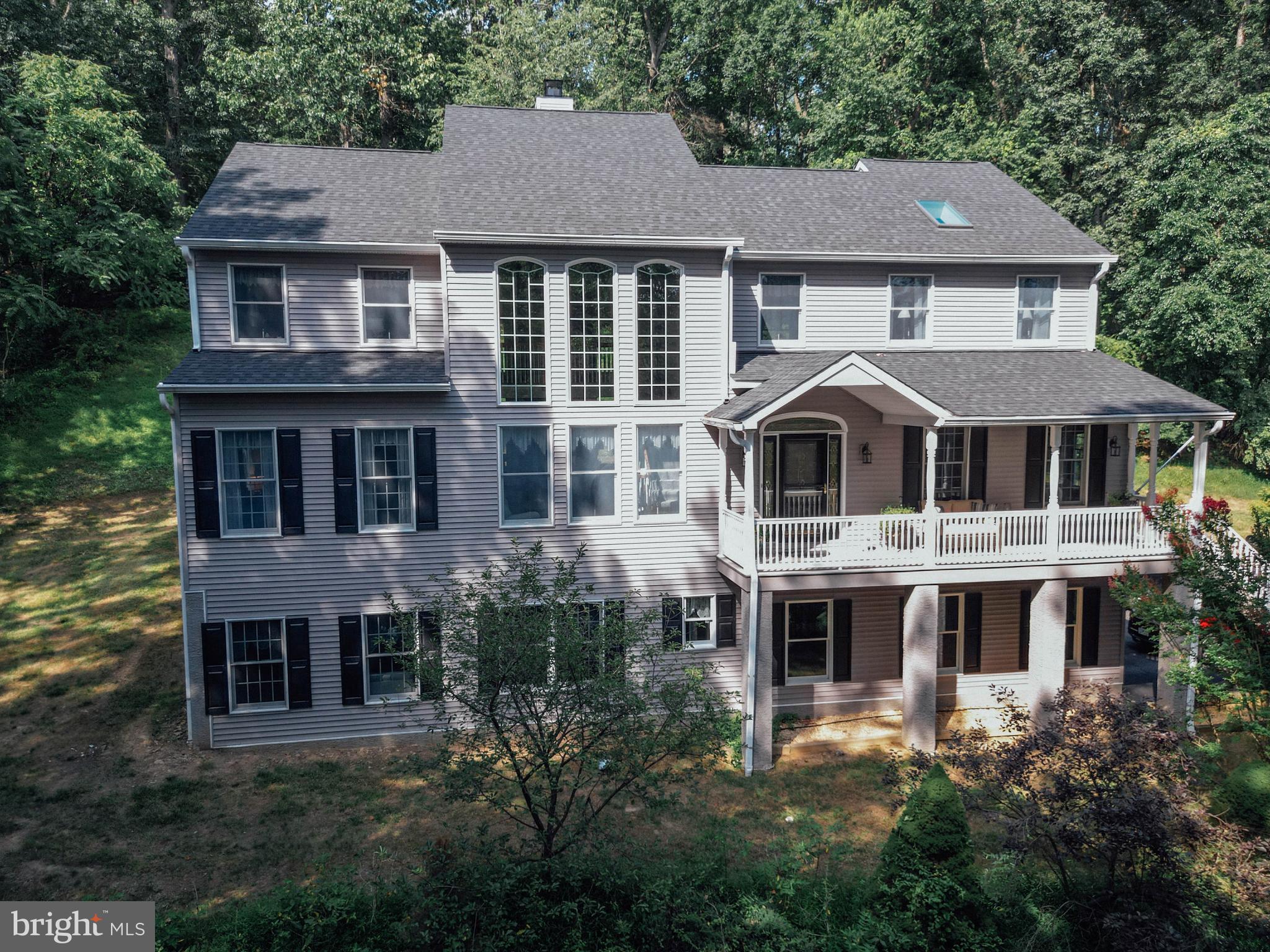 Discover the charm and elegance of 7 Slitting Mill Road, a stunning colonial residence tucked away in the peaceful landscape of Thornbury Township. Approached via a private driveway through mature woods, this home offers a perfect blend of privacy and sophistication.
Step onto the welcoming front porch, where you can soak in views of lush greenery and tranquil surroundings. Inside, the foyer greets you with refined tile flooring, setting the tone for the home’s graceful design. The two-story living room dazzles with abundant natural light streaming through floor-to-ceiling windows, centered around a striking dual-sided stone fireplace that beautifully separates the living and family rooms while maintaining an open, cozy atmosphere.
The heart of the home is the chef-inspired kitchen, featuring rich cherry cabinetry, gleaming granite countertops, and top-of-the-line stainless steel appliances—all included in the sale. Thoughtful touches like under-cabinet and toe-kick lighting, a tile backsplash, and a built-in glass-front china cabinet add both function and style. A generous island with a cooktop, electrical outlets, and seating flows effortlessly into the bright, eat-in dining space, complete with bay windows and a charming chandelier overlooking the back deck, driveway, and backyard.
For more formal gatherings, the elegant dining room showcases classic crown molding, a decorative chair rail with ornate wallpaper, and a centered chandelier, creating an inviting space for special occasions. Conveniently situated nearby, a stylish powder room serves the main living areas.
The main floor also includes two spacious bedrooms filled with natural light and generous closets, perfect for guests or main-level living, complemented by a full hall bathroom with a tiled shower-tub combination. Recent updates include new carpet and fresh paint in several rooms, adding a fresh and welcoming feel.
Upstairs, retreat to the luxurious primary suite, a serene haven featuring cathedral-ceilings, skylights, and a private balcony. The suite boasts a vanity area with a sink, perfect for a morning coffee bar, a spa-like bathroom with a double vanity, soaking tub, walk-in tiled shower, and elegant tile flooring. There are two expansive walk-in closets, one impressively outfitted with built-in organizers, a cozy bench, shoe racks, and ample drawer space. An additional well-sized bedroom and a convenient laundry room complete the upper level.
The finished basement adds valuable living space with a full bathroom and abundant storage, plus a separate entrance leading to the garage and the sprawling 1.7-acre lot. Outside, enjoy a spacious rear deck crafted from maintenance-free composite material, accented with solar lighting on the fence pillars — ideal for relaxing or entertaining.
Additional highlights include a whole-house generator, providing peace of mind and uninterrupted comfort in any weather. All appliances are included, making this home move-in ready.
This exceptional property offers a perfect balance of privacy, luxury, and accessibility to nearby amenities. Don’t miss the opportunity to experience this beautiful home in person — schedule your visit today!