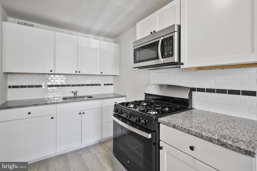 Welcome to 109 Weymouth Rd, a beautifully updated interior row home nestled in the sought-after Lansdowne Park section of Darby. This 3-bedroom, 1-bathroom gem offers a perfect blend of modern updates and classic charm, making it an ideal choice for first-time buyers or anyone seeking comfortable living. Step inside to discover gleaming hardwood floors that flow throughout the main and upper levels. Freshly painted in neutral tones, the home is bright and inviting, ready for you to make it your own. The updated kitchen features durable tile plank flooring, white cabinetry, subway tile backsplash and stainless steel appliances, including a gas stove and microwave—perfect for preparing your favorite meals. The remodeled bathroom boasts a new tub with a stylish tile surround and a tiled floor, offering a spa-like retreat. Replacement windows throughout the home provide energy efficiency and added comfort. Enjoy the outdoors on the front patio and front yard, ideal for relaxing. A driveway offers convenient one-car parking out back. Additional highlights include washer/dryer hookups, a utility tub in the basement, and forced-air gas heating. Don't miss your opportunity to own this move-in-ready home. Schedule your tour today! One of the owners is a licensed real estate salesperson in the state of Pennsylvania.