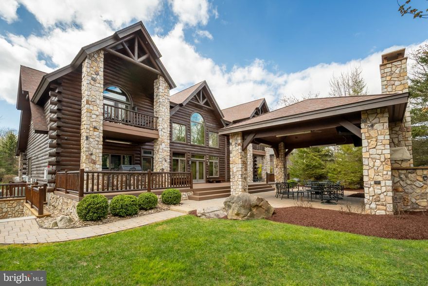 Experience the pinnacle of mountain luxury in this extraordinary custom log estate. Showcasing impeccable craftsmanship and refined rustic elegance, this one-of-a-kind retreat features a deluxe wine room, private sauna, billiard/game room, fitness area, large mudroom, and an indoor hot tub designed for year-round relaxation. Expansive windows from most rooms create a seamless connection to nature. The gourmet kitchen leaves nothing to the imagination, offering a six-burner gas range, large granite island, eat-in bar, cathedral ceilings, and access to the rear patio. The great room boasts a floor-to-ceiling stone fireplace and plenty of large windows that allow you to enjoy the beauty outside during any season. With six en-suite bedrooms and laundry on each level, your guests will be more than comfortable. The media/theatre room with an impressive wet bar is another bonus, and a great place to relax and have family time after a long day on the slopes. Picture hosting unforgettable cookouts with friends and family on the expansive rear brick patio, thoughtfully designed with a built-in grilling area, cozy fireplace, and a comfortable seating and TV area—perfect for relaxing or entertaining in style. With a 3-car attached garage and an epoxy floor, there is ample storage for vehicles and recreational toys. An additional lot provides enhanced privacy, making this an exceptional investment in mountain living. Conveniently located in the North Camp community atop Wisp Resort, premier skiing is just around the corner. There are also two golf courses close by, as well as all the recreation that Deep Creek Lake provides. Adventure and tranquility can both be yours from this remarkable haven!