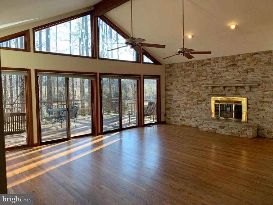 Custom built rambler with finished lower level-over 4,000 finished square feet-built for wheelchair accessibility-Open/Unique Floor Plan(please see attachments)-Den/3rd Bedroom on Main Level-4th possible bedroom with walk-in closet lower level-Awesome family room with cathedral ceilings/stone fireplace/ceiling fans & sliding glass doors to large deck-Separate dining room w/vaulted ceilings-Kitchen with double sinks/cathedral ceilings/ceramic tile floors-Breakfast nook off kitchen with bay windows-Large master bedroom with walk-in closet and hardwood floors-Oversized side load garage with concrete ramp to main level/mud room-Walkout lower level with rec room/media-storage room/workshop/3rd-4th bedroom, full bathroom and another storage room-Private cul-de-sac lot backing to trees-Large deck overlooking rear yard-enjoy winter sunsets from family room/deck