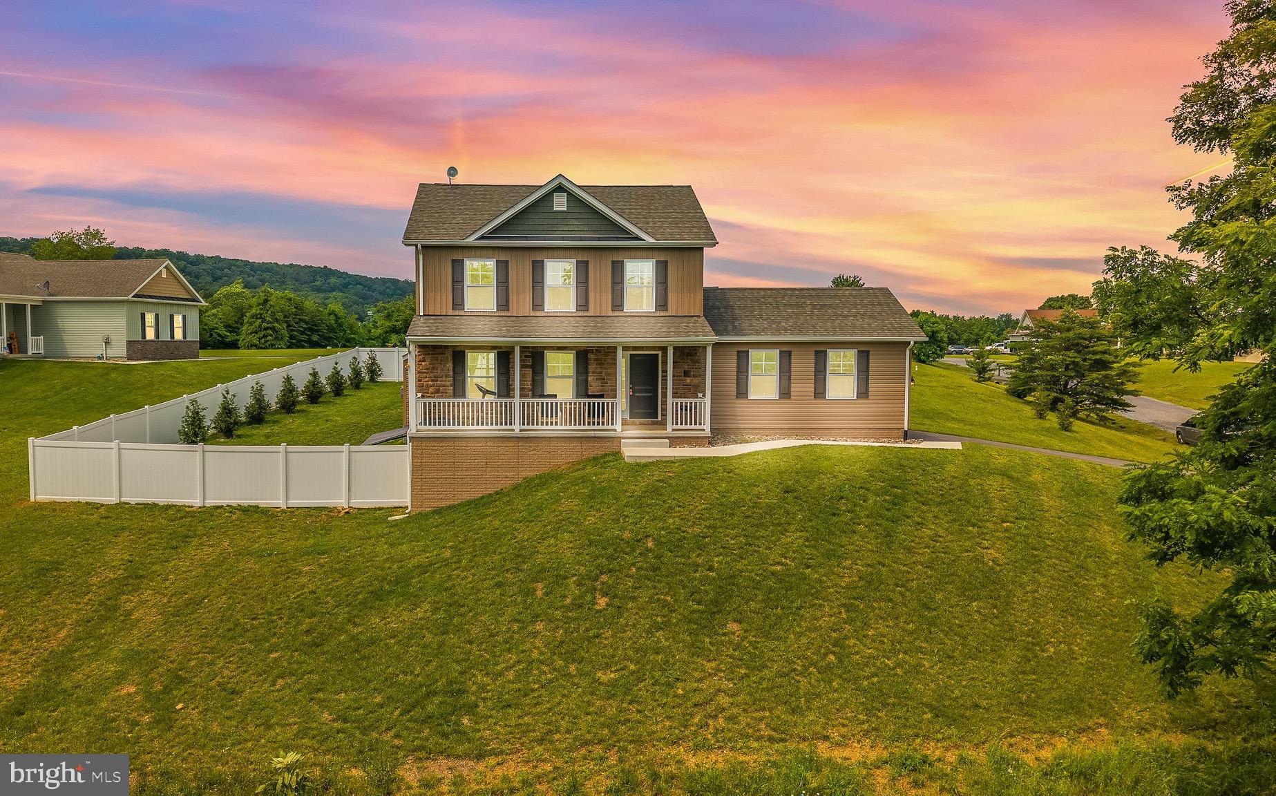 Stunning, less than 2-Year-Old Colonial on 1.04 Acres, just 5 Minutes to Cacapon State Park! Now is your chance to own this beautiful, like-new colonial perfectly situated on a private 1.04-acre lot, only minutes from downtown Berkeley Springs and the scenic Cacapon State Park! This spacious and thoughtfully designed home offers a blend of elegance and comfort, featuring a welcoming front porch with picturesque mountain views and a newly added vinyl privacy fence lined with young trees and lush landscaping. The backyard is ideal for entertaining with a back patio, a new seamless awning, and peaceful wooded surroundings.
Inside, you’ll find a warm and inviting living room complete with a cozy fireplace, a formal dining room for special gatherings, and a modern kitchen boasting upgraded countertops and stainless steel appliances. The home also includes a separate laundry room and zoned HVAC for year-round efficiency.
Upstairs features generously sized bedrooms with walk-in closets, while the mostly finished basement includes a private bedroom and full bath, perfect for guests. Plus, a separate utility/storage room.
This property offers the best of both worlds: a serene, private setting with convenient access to recreation, dining, and shopping. Don’t miss this opportunity to own a move-in-ready home in one of the most desirable areas of Berkeley Springs!