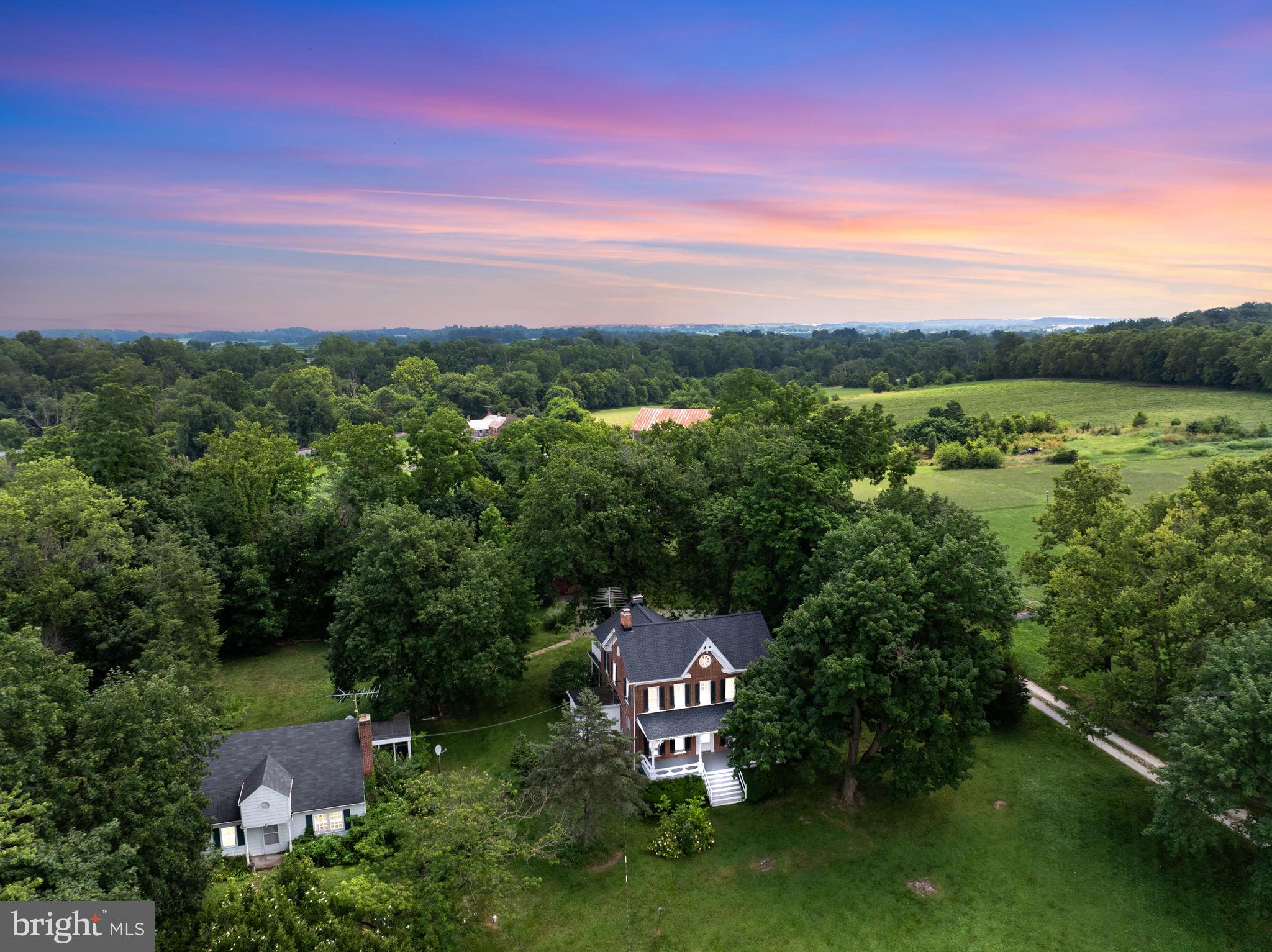 Rare Opportunity in Historic Linwood Village! TWO homes on 3 acres — perfect for multi-generational living, income potential, or future subdivision. Each home has its own well and septic.
Main House (c. 1866 – Washington Senseney House): Charming brick colonial with 3 bedrooms, 2.5 baths, hardwood floors (under carpet), formal living and dining rooms, two fireplaces, library/office, screened porch, and walk-up attic. Large basement with finished hobby space, utility room, and storage. Located in a historic village but not under historic restrictions — renovate or modernize to suit your style.
Detached Cottage: Single-level living with 2 bedrooms, 1 full bath, living room with fireplace, kitchen, screened porch, and hardwood floors. Separate well/septic. Previously rented and lead paint compliant.
Level 3-acre lot with tree field and outbuildings — ideal for small animals, gardening, or recreation. Spacious yard with beautiful views and road frontage.
Estate Sale – Sold AS IS Do not use side steps of main house (unsafe).
Conveniently located near New Windsor, Union Bridge & commuter routes. Endless potential — live in one, rent the other, or create your dream homestead.