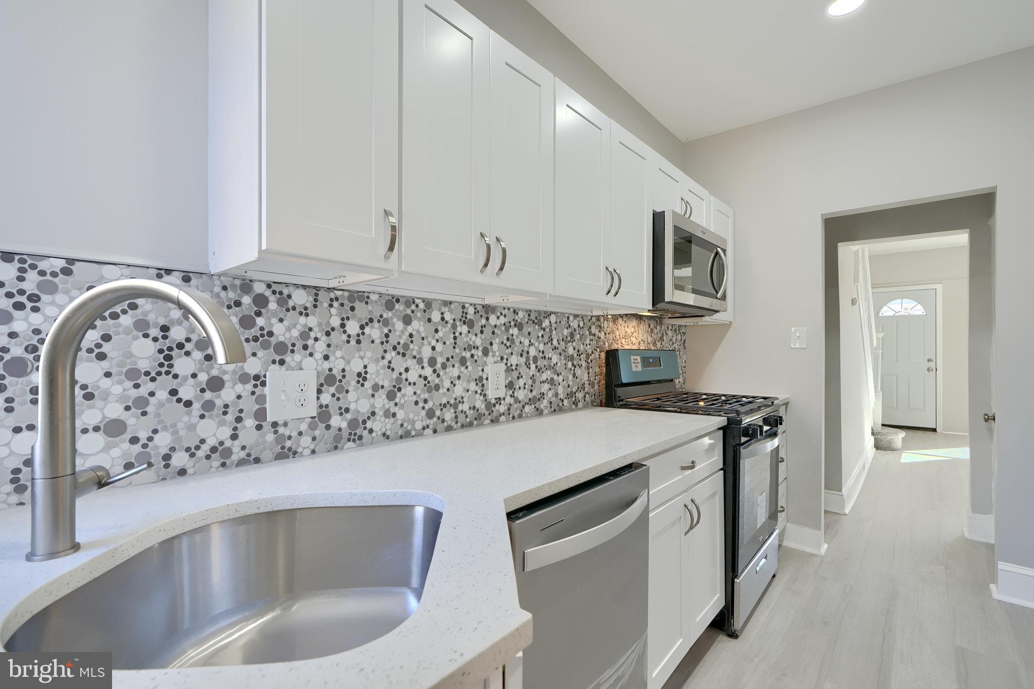 *Ask LA about Special Seller Concessions* You will Love this Tasteful Renovation done with Permits and Inspections! All New Kitchen with Quartz Countertop, Stainless Steel Appliances, White Shaker Cabinets, Cool Backsplash. New Bathrooms with Custom Ceramic Tile & Designer Fixtures; the Gold Accents in the Upstairs Bath are Awesome ! Finished Basement Suite with Large Family Room, Bedroom with Private Bathroom, and Bonus Storage Room. Large Master Bedroom, Elegant Lighting, New HVAC System, Replacement Windows, Luxury vinyl Plank Flooring, Fenced Front & Back Yards. Modern Updates, Large Welcoming Rooms, and Great Style. Also see our other listing on this block, 4003 Fairfax
