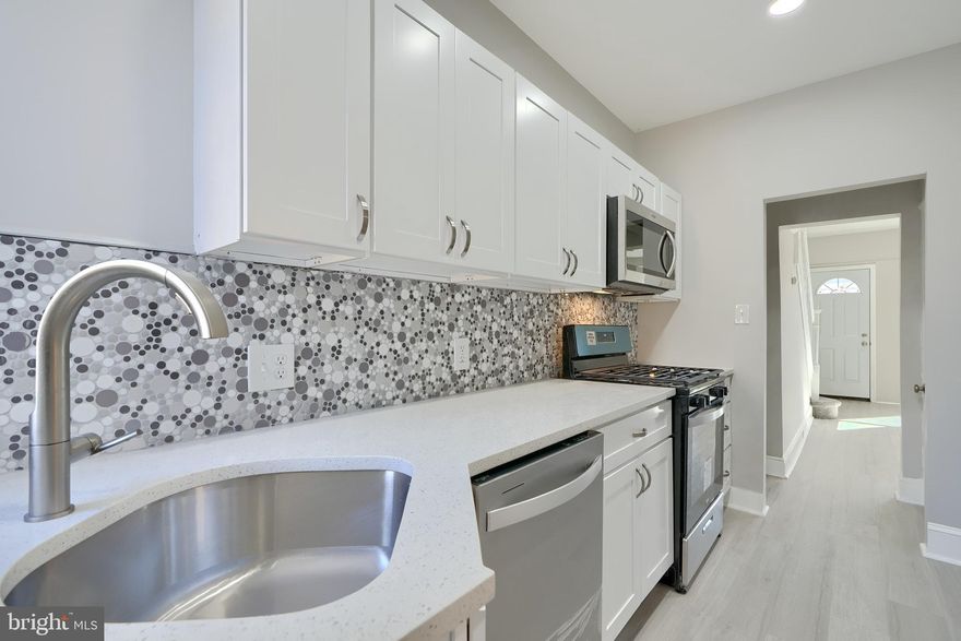 *Ask LA about Special Seller Concessions*  You will Love this Tasteful Renovation done with Permits and Inspections!  All New Kitchen with Quartz Countertop, Stainless Steel Appliances, White Shaker Cabinets, Cool Backsplash.  New Bathrooms with Custom Ceramic Tile & Designer Fixtures; the Gold Accents in the Upstairs Bath are Awesome ! Finished Basement Suite with Large Family Room, Bedroom with Private Bathroom, and Bonus Storage Room. Large Master Bedroom,  Elegant Lighting, New HVAC System, Replacement Windows, Luxury vinyl Plank Flooring,  Fenced Front & Back Yards. Modern Updates, Large Welcoming Rooms, and Great Style.  Also see our other listing on this block, 4003 Fairfax
