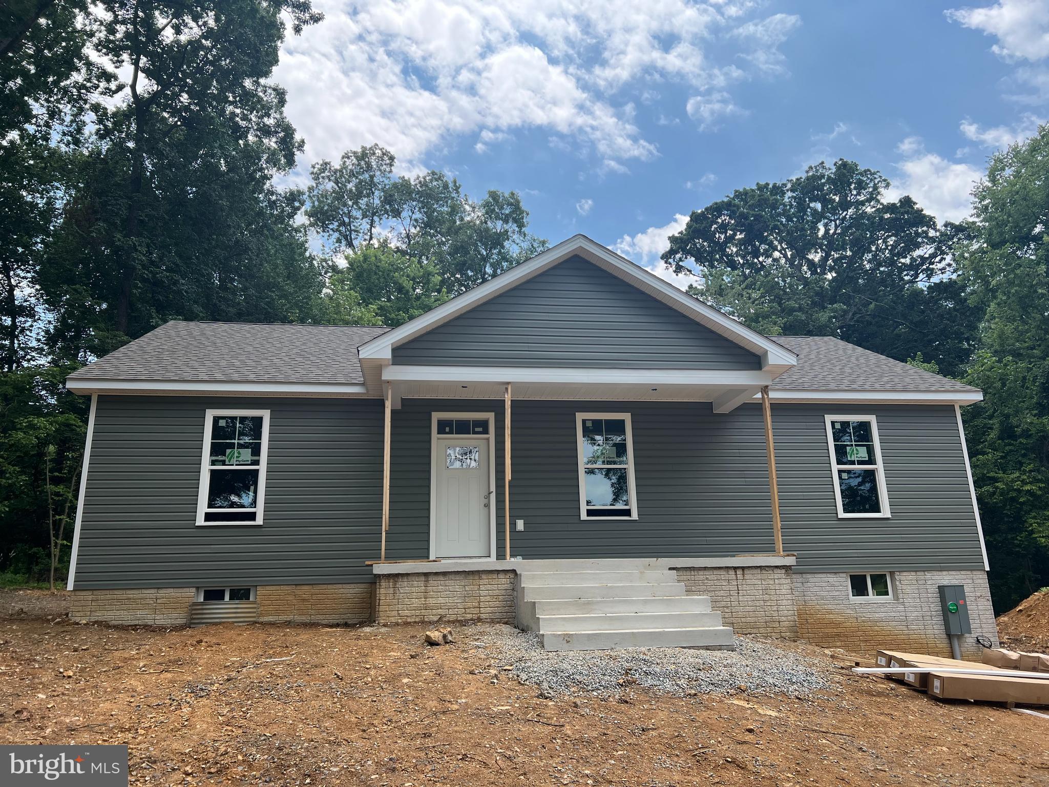 NEW CONSTRUCTION 60 days from completion! No HOA on 1.3 unrestricted wooded acres minutes outside of Shepherdstown! One level ranch home hosting split bedroom plan with three bedrooms and two full bathrooms with open living/kitchen/dining layout. Kitchen will boast white cabinets, island, granite countertops, and stainless appliance package. Open living/dining space with cathedral ceilings and main living area w/ LVP flooring selection and electric fireplace. Primary bedroom suite offers walk-in closet and full bathroom w/ tiled walk-in shower. Additional finished space in the basement with full bathroom. Enjoy sipping sweet tea from covered front porch. Just minutes from the conveniences of town w/ shopping, restaurants, and medical facilities nearby. Purchaser responsible for paying transfer tax stamps. Photos are current as of 7/3!