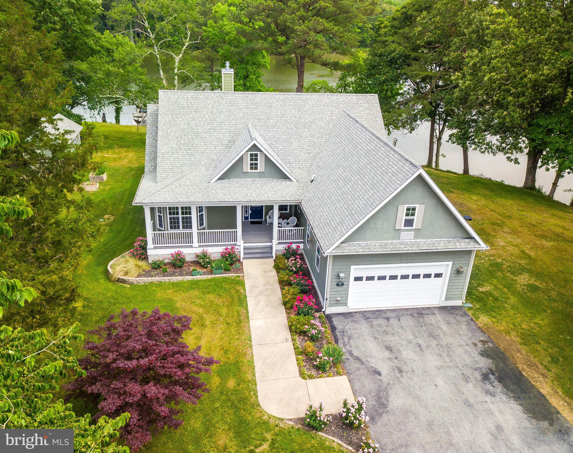 This is the perfect waterfront spot, inside and out! Sweeping views and deep, sailboat depth water on Jutland Creek, just 5 minutes from historic St. Mary's City and easy access to the Chesapeake Bay. This charming custom home, built in 2007, is situated on over an acre and features quality materials, a wonderful floorplan primarily on one level, and plenty of creek side windows to enjoy the view. This home has much to offer - beautiful, fully equipped Chef's Kitchen with breakfast area, beverage station, custom-outfitted cabinets, gorgeous granite counters, stainless appliances & access to covered back porch and patio; Great Room with vaulted ceiling, built-in bookshelves and gas fireplace; Owner's Suite featuring enormous creek view, dual walk-in closets, large Owner's Bath with radiant heat floors; on the opposite side of the main level, find two additional Bedrooms + two full Baths, and separate Office/Craft Room; inside access stairs to Bonus Room over 2-car Garage; Sauna Room and Laundry; sleek maple flooring throughout main living area. Outside, enjoy plenty of landscape/hardscape, front and back porches, patio with firepit and shed. Pier has 7k boatlift, accommodates 2 jet skis, and has electric & water. What a perfect place to enjoy waterfront living!
