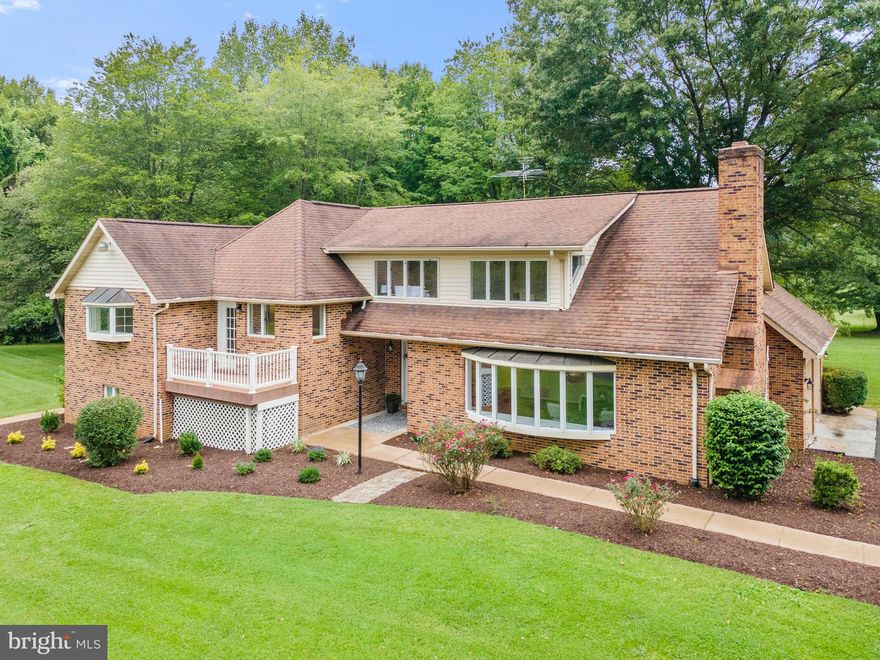 Lovely, brick home on 3+ acres.  Spacious main level featuring huge family room with brick fireplace; kitchen with buffet counter and large island; and dining room with a wall of windows overlooking side yard.  Upper level has surprises around every corner with a large master suite, loft which could be a perfect in-home office, large bonus room above the garage, 2 additional bedrooms and full bath.  Lower level has a kitchenette, living area, 4th bedroom, full bath and separate entrance - could be great apartment for income potential or in-law suite.  This lovely home has a large wrap-around covered deck, perfect for enjoying the outdoors.  Situated in a quiet setting, great commuter location, the Kettle Run school district and COMCAST cable!