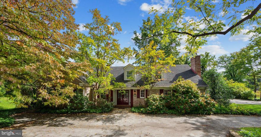 Bursting with potential, this gracious, brick Cape Cod is nestled on a leafy
corner lot in Villanova’s coveted Parkes Run neighborhood with priceless views of 
Ardrossan Farm. For motivated, visionary buyers, this is an incredible opportunity
to put your stamp on a premier Main Line address with historic roots. Built around
a sprawling stone terrace and landscaped grounds, this home prioritizes scenic
views and outdoor access at every turn. From the front driveway with stone
retaining wall, double glass entry doors open to a sunny brick foyer that offers
unobstructed sightlines to the expansive back patio and greenspace. A short side
hallway leads to a bright and inviting family room with beamed ceiling, recessed
lighting, custom built-ins and brick accent wall with gas fireplace. The family
room connects to a cheery kitchen with plentiful cabinetry, center island and large
architectural window framing the rolling hills of Ardrossan Farm. From the
kitchen, an arched opening reveals a glorious, sky-lit sunroom with vaulted ceiling,
oversize window seat with stone bench and a wall of glass sliders leading to the
home’s rear grounds and terrace. The sunroom also offers convenient access to the
first-floor powder room and oversize two-car garage. Off the other side of the
kitchen sits a lovely, light-filled dining room and a large living room beyond with
wood-burning fireplace and yet another wall of glass sliders. On the opposite wing
of the main floor, you’ll find a spacious corner bedroom with ensuite full bath, plus
the primary suite with ensuite full bath, ample closet space and direct access to the
rear stone patio. Upstairs features three additional bedrooms—all with enviable
views of the home’s spectacular landscape—plus a split hallway bath. Outside, an
elegant stone terrace runs the entire width of the home, with multiple areas for
lounging and dining al fresco. Stone steps lead to an in-ground pool surrounded by
over an acre of private, fenced greenspace. At the rear of the property, a gurgling
stream runs beneath one of the home’s most distinctive features—a historic Spring
House circa 1860. The two-story structure was converted into a charming guest
cottage by the current owners, who went to great lengths to incorporate modern
features and amenities while preserving its historic character and charm. The
cottage boasts a full kitchen with island seating, a cozy living room with wood-
burning fireplace, a covered back porch, two bedrooms and a full hallway bath.
While the Spring House features its own entrance and parking, it also connects to
the main house via a covered brick and stone walkway. Bringing the very best of
town and country living to one enviable address, this distinctive property is just
minutes from downtown Wayne and other popular Main Line destinations. Zoned
for award-winning Radnor Township School District and close to several premier
private schools too! Please note this property is being sold as-is.