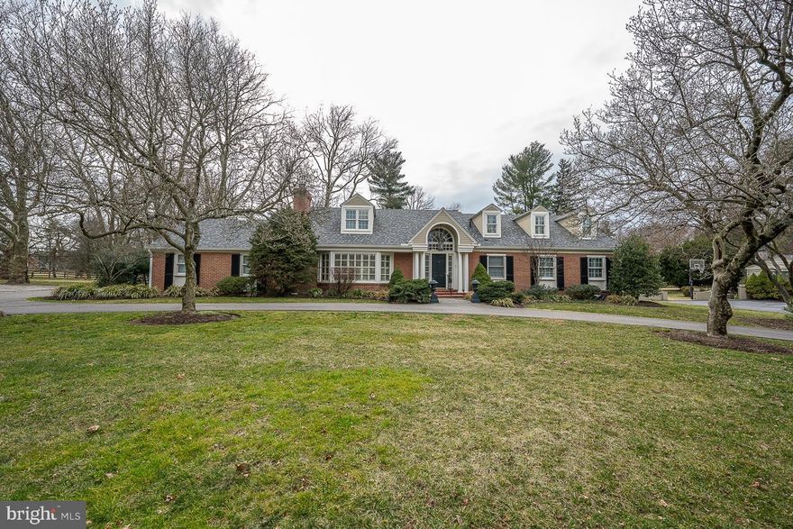 Spacious sunlit brick Cape has dynamic curb appeal and welcoming interior spaces that offer a flexible open floor plan adaptable to owner needs and preferences.  Bright two-story entrance hall leads to living/great room (21x19) with raised- hearth wood-burning- fireplace and 65" wall-mounted TV.  Double French doors invite natural light and open to brick terrace and level grounds. Dining room (22x17) with lovely bay window and gas fireplace flanked by built-ins. Eat-in kitchen (15x13) with center island, granite countertops, stainless appliances and easy access to laundry 
,2-car garage and entrance to rear grounds. Capacious main bedroom (20x140) with ensuite bath and two closets, one walk-in. Additional first level bedroom (14x14) presently serving as office/den with handsome built-ins and direct access to hall bath. Staircase to second floor reveals sunny atrium (16x14) with three windows overlooking rear grounds and neighboring estate. Two additional bedrooms (28x19 and 18x12) each with dormers and window seats. Ample closets, one walk-in. Lower level features large carpeted entertainment area (30x19), wet bar with counter and refrigerator, exercise and powder rooms, tile floor to outside 
entrance. Unfinished area has well-lighted work bench for home or hobby projects.
Great storage space, fireproof filing system and combination safe. Home features beautiful hardwood floors and custom shutters throughout. Semi-circular driveway. Situated on quiet street in prized Gladwyne location. Easy access to highways, public transport, shopping, restaurants, outstanding public and private schools.