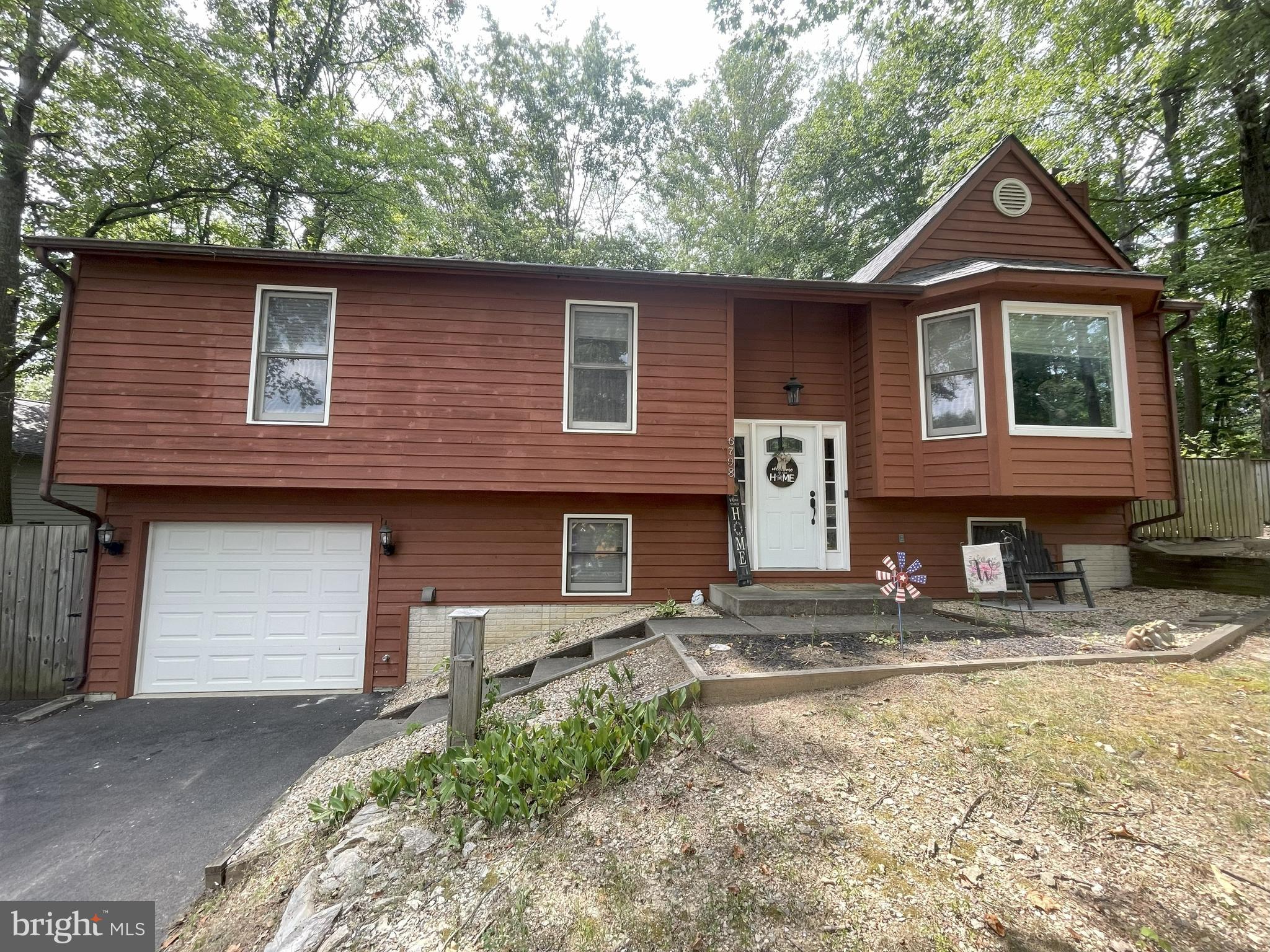 There are lots of magical modern updates that have been done to this 3 Bedroom 2.5 Bath Split Foyer with a One car Attached garage that is located in the much sought after neighborhood of Lake Linganore! New 30 year Architechtural shingled roof installed in 2022. Newly remodeled Kitchen in 2018 to include Stainless appliances, hardwood flooring, granite counter tops, Kitchen Island, Ceramic tiled backsplash and more. Open styled layout with Cathedral ceilings and skylights to let in all the natural light. Woodburning firepalce in Living Room. Large Master Bedroom with a huge newly renovated Master Bathroom to include a gigantic Walk in Shower with Stone floor, ceramic tiled shower surround, , 3 setting shower head to include a rain shower and jets. and light sensing LED Lighting throughout. Renovated Open style basement has Engineered wood flooring, custom stone worked walls with custom burnt wood rails , Built in Desk area with custom burnt wood top,, Wet bar with sink, Custom Bar Top and custom cabinetry and mini fridge. Barn Door Separates Laundry room with Automatic lighting so no switches needed. Custom Half Bathroom with Barrel Sink, auto lighting and pocket door for your privacy. Walkout to basement garage. Large newly renovated deck off of kitchen for all your entertaining needs. This place has it all! Within steps to the stunning Lake Merle and the Balmoral Trail Head.