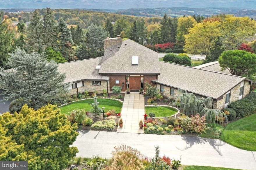 Wheel into the circular driveway and walk through the designer front doors and be prepared for a viewing experience that compares to none!!   You will be greeted by a grand two story open foyer with vaulted ceilings and an open spiral staircase to an upper loft.  As if this contemporary beauty wasn't fantastic enough, the current homeowner did a plethora of improvements that will blow you away (See List of Improvements).  Situated on a 1.05 acre lot in the prestigious community of Wyndham Hills, this gorgeous corner property boasts 5700+ square feet of finished living space. This includes 5 bedrooms, 3 full baths, and 2 half baths.  The gourmet kitchen has granite countertops, all new built-in stainless steel appliances, tile floors, cherry cabinetry and,  since the wall has been opened , an incredible view of a remodeled family room.  This family room has new barn beams, a reworked wood burning fireplace with stone surround and new milled poplar wood treatments and built-ins.  There is also a vaulted ceiling and a bank of casement windows that overlooks the outside pool area, the large covered patio area and the recently installed oversized pond and landscaping.  The fencing around the pool area was extended to encompass the entire rear yard area.  The wall between the dining room and living room has also been excavated to allow a better flow between these rooms.  An incredible brand new custom slate electric fireplace in the living room adds warmth and class to a once ordinary room.  The master bedroom and walk in closet are both oversized with vaulted ceilings. The master bath has been remodeled to include cherry cabinetry, tile flooring,  granite countertops and double shower heads.  The lower level is finished and has lots of storage areas and a half bath.  All casement windows are Pella, the roof was installed in 2019 and there is a 3 car garage.  Other improvements include all new paint, many electrical upgrades, custom lighting, new garage doors, new a/c compressor and exchanger in August 2023, many poplar wood trim treatments, herringbone carpet replacement, custom wood blinds.  Whether you're lounging by the pool, partying on the patio, or socializing inside, this home will be sure to please every lifestyle.  Close to shopping, downtown entertainment,  and major roads this home is also located in the desirable York Suburban School District.  (Please note:   this transaction is subject to them finding a home of choice...their temporary housing arrangements fell through)