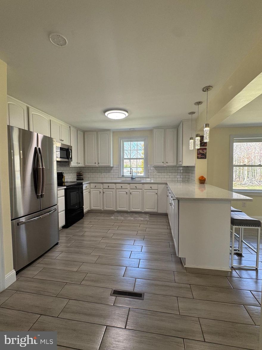 Welcome to this beautiful Rambler in the peaceful community of Welcome, Maryland. Surrounded by open land and nature, this home offers the perfect blend of rural serenity and modern comfort. The property has been thoughtfully updated, featuring elegant granite countertops, sleek white cabinets, stylish light fixtures in the kitchen and bathrooms, renovated bathrooms and bedrooms, and polished floors throughout. It has been thoughtfully painted, adding a bright and clean feel to every room. Enjoy the comfort of an updated kitchen, a chimney, updated roof and siding, giving you peace of mind for years to come. Inside, you’ll find 3 spacious bedrooms, 2 full bathrooms, and a separate laundry/storage room for added convenience. With no HOA, you can enjoy more flexibility and fewer restrictions. The home sits on a large lot with plenty of parking space, offering privacy while still being just minutes from shopping, dining, and outdoor recreation by the scenic Potomac River. If you're seeking a quiet, connected lifestyle within reach of La Plata, Waldorf, and Washington, D.C., !!!!This home is a must-see!!!!!