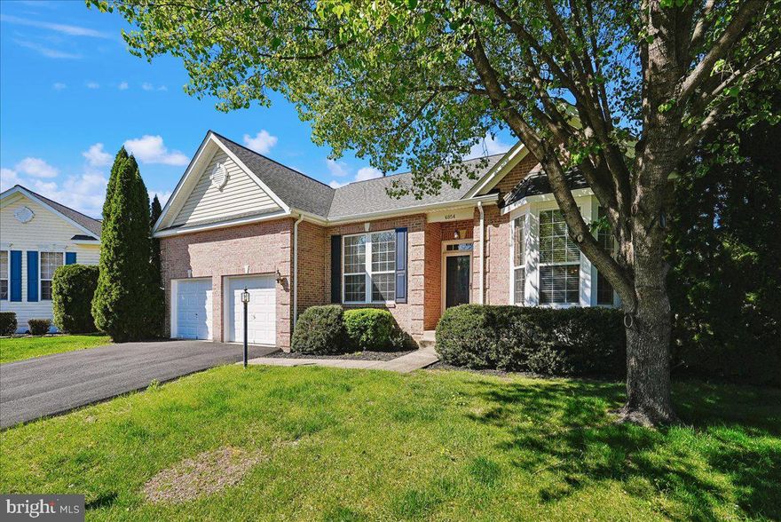 One of the largest models in this charming community—featuring exceptionally low HOA fees—this handsome brick-front home offers the perfect blend of space, comfort, and smart updates. Hardwood floors, abundant natural light, and beautifully defined Living and Dining Rooms create an inviting and elegant, yet extremely comfortable vibe.

The heart of the home is the expansive Kitchen and Great Room across the back, designed for both everyday living and entertaining. The bright, open Kitchen is a place you’ll truly enjoy spending time in. Notable highlights include warm-toned granite counters, a tile backsplash, under-cabinet lighting, a copper sink, and a pantry. The Great Room showcases a striking gas fireplace with floor-to-ceiling stone and white built-ins —a true focal point that adds warmth and character. Plus, there's a Breakfast Nook with a beautiful bay window to enjoy your morning coffee and start your day!

All three bedrooms are conveniently located on the main level, including one with custom-built-ins—ideal for a home office or a flexible guest space.  The King-sized Primary Suite is a retreat to look forward to! High coffered ceilings with recessed lights and a fan, a big walk-in closet, and a spa-like bath with dual vanities, a large soaking tub, and a separate big shower.

Downstairs, you’ll be pleasantly surprised by the incredible amount of additional living space. The walk-up lower level features a huge Rec Room with natural light, a convenient kitchenette, and FOUR additional bonus rooms perfect for hobbies, fitness, or creative pursuits. One is a perfect Bedroom except it isn't to code.

Major systems have already been taken care of, including a newer roof and hot water heater, along with a brand-new HVAC—giving you peace of mind for years to come.

And the lifestyle extends outdoors—step out back to a large paver patio, ready for relaxing evenings or entertaining under the open sky.

This is truly an exceptional home - one you'll enjoy for years to come!  Make it yours today!