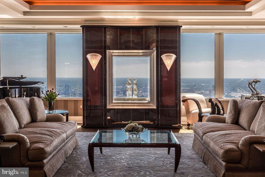 Perched high above the Philadelphia skyline, Two Liberty Place stands as a beacon of luxury, offering breathtaking, unobstructed views. The residence features expansive windows and a sprawling 2,400± square foot terrace, showcasing panoramic vistas to the east, west, and north. Revel in sights of City Hall, the Ben Franklin Bridge, and the Delaware and Schuylkill rivers. The terrace seamlessly transitions into several pristine indoor spaces, creating an ideal setting for sophisticated entertaining.

Elegantly designed with a nod to the Art Deco era, the interior showcases antique French fixtures and luxurious materials throughout. Enjoy a cozy evening by the macassar ebony wood fireplace in the formal living room after indulging in cocktails in the spacious gourmet kitchen. The kitchen island is fully equipped for professional caterers while remaining perfect for any home chef. Wine connoisseurs will appreciate the temperature-controlled, 1,500-bottle wine storage and butler's pantry adjacent to the kitchen. The sumptuous private suite features a double Carrera marble bath and two expansive walk-in closets. Retreat to your private lounge that opens onto the terrace, offering a serene escape with stunning views of Philadelphia below.

This pet-friendly high-rise offers an entire floor dedicated to luxury amenities, recently upgraded with a complete renovation. Dip into the refreshing pool, relax in the sauna after an intense session in the state-of-the-art gym, or take advantage of the car service to explore the vibrant city. Two Liberty also features a 24-hour concierge and an exceptionally friendly staff, ensuring all your needs are met around the clock. With an unbeatable location and a perfect Walkscore of 100, residents enjoy effortless access to public transportation, an exciting culinary scene, and an array of shopping options ranging from high-end boutiques to charming local artisan shops.