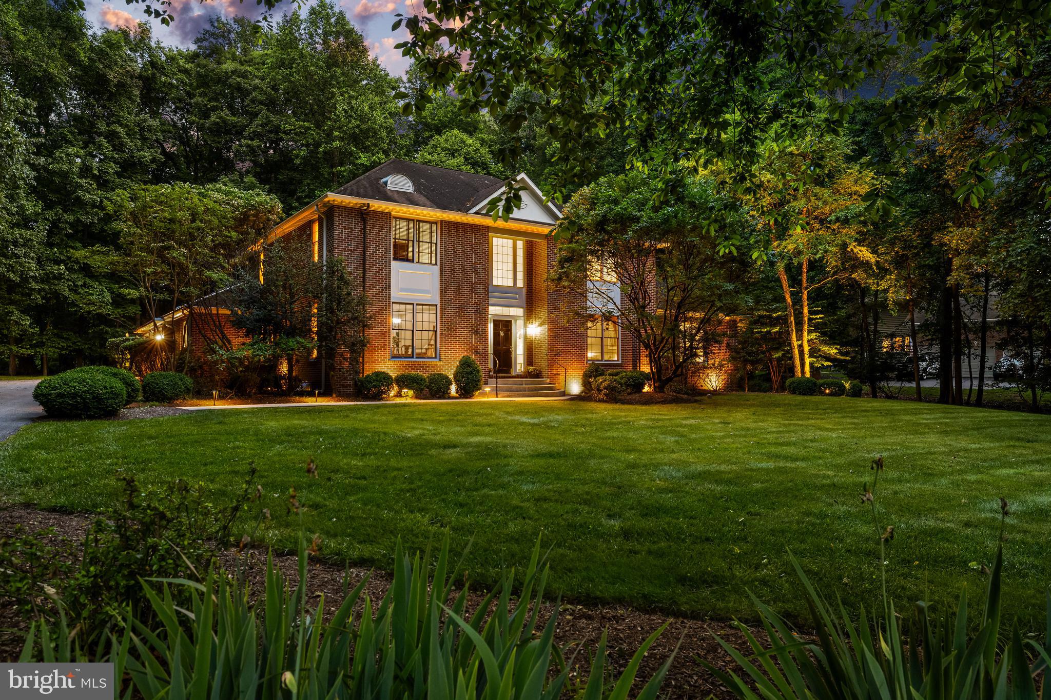 This bright and cheerful custom built Chestnut Woods home is in absolutely pristine condition with glowing hardwood floors, immaculate woodwork, generously proportioned living spaces and a fabulous open floor plan. The expansive sought-after main level primary suite boasts dual walk-in closets w/ organizers, seamless glass stall shower and jet tub. A second staircase conveniently connects the second level hallway to the main level breakfast room. The spacious kitchen offers plentiful solid wood 42" cabinetry, island and breakfast bar seating plus a simply fabulous walk-in butler pantry that boasts extensive storage and prep space. The fully finished lower level features space for exercise, billiards, a wet bar and a huge home theater. Plenty of storage possibilities! Enjoy entertaining on the brick paver patio, taking in the sun, sights and sounds of nature.