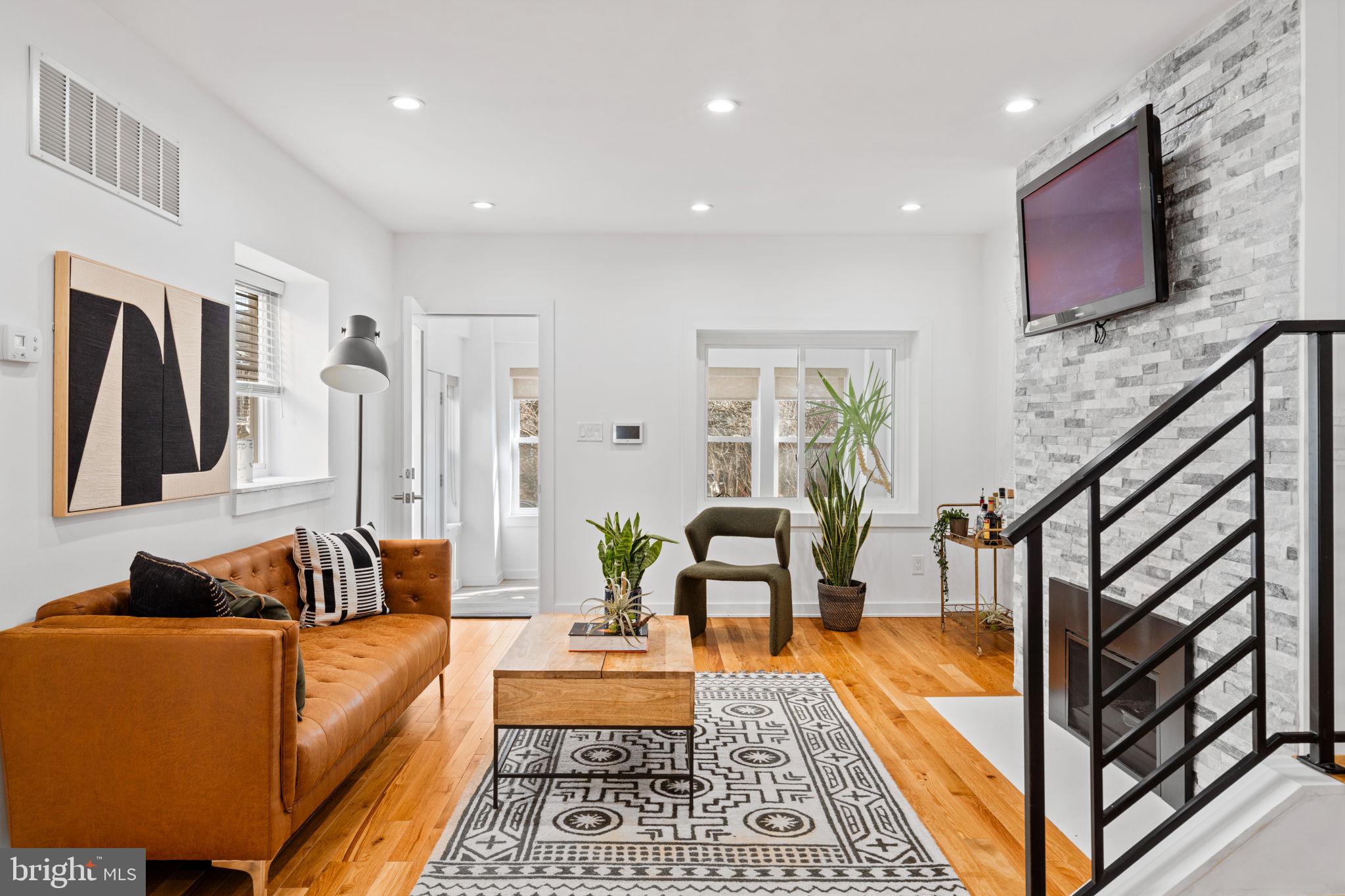 If the search for the perfect home eluded you last year, you’re in luck. Within the northern reaches of East Mt. Airy in walking distance to cobblestoned Germantown Avenue and a stone’s throw from the Wissahickon, sits that very home you’ve been waiting for. You can’t help but fall for the storied neighborhood but you worry that you don’t have the chops to restore or maintain the 100+ year-old homes so commonly associated with it. Behold 511 E Mt Airy Avenue, a lovely twin completely renovated from top to bottom without a detail spared. You didn’t think the bells and whistles often associated with new construction existed in Mt. Airy. Alas, it does. A handsome façade is a welcoming invitation and once inside, a bright and cheerful sunroom awaits. The living room boasts wide oak flooring, recessed lighting, and a modern gas fireplace with stone surround which invites you to have a seat and relax. You admire the spacious open floor plan and the natural light that dances around the room, features often impossible to achieve in older homes. The kitchen is calling your name and it does not disappoint. Stylish black custom cabinetry, quartz countertops, and a stainless steel appliances offer a classic design and a large waterfall island adds a modern touch suited for today’s living. You can’t help but smile as you think of entertaining family and friends in this space this summer. On the second floor find three bedrooms, one with a vaulted ceiling, and a hall bath with a floating double vanity, marble tile flooring, and a deep soaking tub with subway tile surround. Downstairs, the basement is completely finished with high ceilings and a full bath, adding additional living space. Home gym, office, art studio, guest room – the possibilities are endless. Additional home features include a 3 year-old HVAC system, new electric, plumbing, and a tankless hot water heater. Two-car parking and a fenced-in yard bring the best parts of suburban living to the city. You love that Mt. Airy offers a vibrant residential community and an eclectic mix of restaurants, shops, and cafes and is served by two train lines. You’re already picturing enjoying a morning latte and crepe from High Point Café, and Tuesday night Quizzo at Mt Airy Taproom. You’ve picked your cozy seat at the bar at the legendary local favorite, McMenamin’s, and for date night, you’re envisioning dining under the stars at Jansen. You truly didn’t think a home like this existed here but you’re so glad it does. Your search is over. Welcome home.