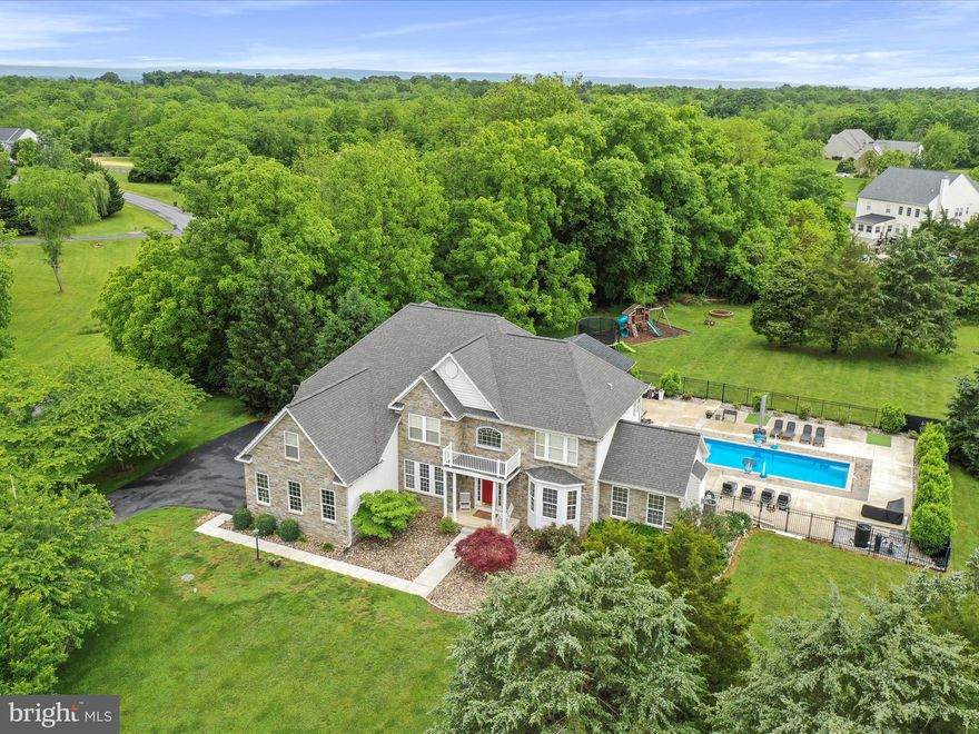 Welcome to 40 Inaugural Way, a beautiful, stately home in the desirable Preserve at Barleywood neighborhood. This is a builder model home with all the upgrades, and has over 5,600 square feet of finished indoor living space, plus a huge screened porch, heated saltwater pool, and tons of outdoor living space (with both wood and gas fire pits). The private 3-acre corner lot is a mixture of mature trees and gently rolling lawn. Two story living room has a gas fireplace and is adjacent to the huge kitchen and sunroom. Work from home in the main level office with fiber optic internet. Expansive owners suite has its own two-sided gas fireplace. Basement is finished with a huge rec room, exercise room, and full bathroom. This is a rare opportunity to own a home of this size and quality in commuting distance of Northern VA. Close to historic downtown Charles Town and Harpers Ferry. Won't last long! Come see it today.