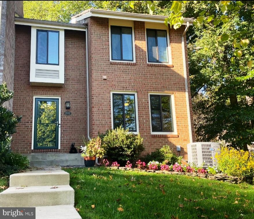 NO LAWN CARE!  ACROSS THE STREET FROM LAKE THOREAU!   Welcome to this gorgeous, meticulously maintained 3/4 BR & 3.5BA end of the row townhouse with three sides brick, giving lots of light.   Take your kayaks across the street to Lake Thoreau or just enjoy the dock!  You can also enjoy the wonderful Reston trails which wind around the neighborhood and around the lake!  (The owners are currently using the "4th" bedroom as an office, but can be converted back to a separate bedroom if needed).
New hardwood floors in entrance, dining and family room.  ceramic tile in huge kitchen with built-ins, and an eat-in area plus plenty of space for entertainment, leading to a spacious rear deck and view of trees!  Granite countertops and S/S appliances complete this beautiful kitchen!
The upper level has two bedrooms and the primary bedroom has an attached room which is being used as an office.  There is a large mirrored dressing area off the primary bathroom with it's own sink, to go along with a separate sink and shower in the primary bathroom.  Another large bedroom and full bathroom complete the upper level.
Lower level has a full bathroom,  another large bedroom, plus a spacious rec room.  The fireplace has a new stone façade.  There is also a dry bar with cabinets and sliding glass doors to a new patio!  Some updates include a new roof (2023), newer patio w/ pavers and freshly painted throughout.  PARK IN SPACES 77 & 78