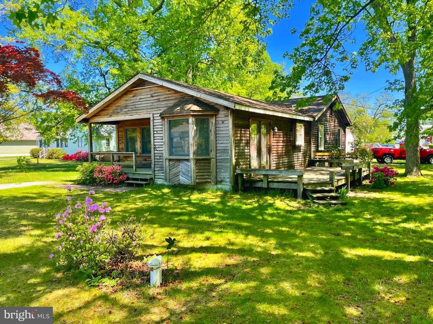 Fall in love with the beautiful 3 bedroom home tucked away in the desired Bayside Beach Community.  This move in ready home features a wonderful corner lot, tons of light with oversized windows.  Home has been freshly painted.  A spacious eat-in kitchen open to the dinning room area, great for entertaining guests, absorbs natural light by the large bay window in the front of the house, and glass side door leading to the deck complete with custom bench seating, and a gorgeous large front porch for those quiet summer evenings.  Home also features a 3 year old roof, a detached garage, and a shed in the back yard for all your storing needs.  Enjoy your home away from home with your own private community beach with spectacular views of the bay, a boat marina, a pavilion, and a playground with a basketball court.