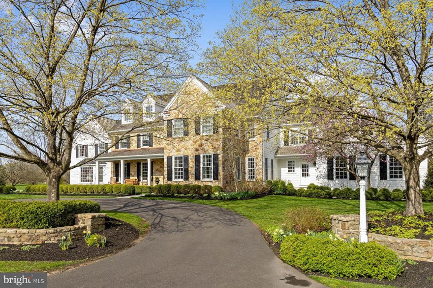 Tucked away on over 5.5 secluded acres, and backing to a 170-acre preserved farm, this beautifully expanded and updated classic home offers the rare combination of tranquility and community. Located in The Preserve section of the coveted Weatherfield neighborhood, this fine property is approached via a long, graceful circular driveway that opens to the stately stone fronted home with inviting covered front porch entry.  Framed by lush professional walkways and terraces, there are sweeping lawns and panoramic views in every direction.  This exceptional estate is more than just a primary residence.  In addition to the 4-5 bedroom 5.2-bath main home, the secluded compound includes a 2-bedroom guest house with elevator (2021), heated pool and spa, a fully appointed pool house with kitchen and half-bath/changing cabana, an outdoor shower, and five climate-controlled garage bays. Beautifully reimagined and renovated, the main home showcases refined finish throughout. Specialty cherry hardwood and limestone flooring, deep crown & base moldings, classic wainscoting, built-in lighted cabinetry, coffered ceilings, French and pocket doors, and deep sill windows lend timeless elegance.  Baths and the sun-filled kitchen have been totally renovated, using Carrera marble and other premium finishes. Each bedroom offers en-suite baths w/radiant heat, and custom closets.  Gracefully proportioned rooms define the main level.  A formal living and dining room offer sophisticated entertainment spaces, while the family room with coffered ceiling and gas fireplace opens to the stunning chef’s kitchen and sunroom. The show-stopping Great Room features 2-story ceiling height, a marble fireplace with raised hearth, and a light filled bay window alcove – perfect for large gatherings.  The custom chef’s kitchen is a dream, with white cabinetry, Carrera counters, a large center island with seating, top-tier appliances including a Wolf 6-burmer gas range, and a spacious breakfast area for casual dining!  A butler’s pantry with wine fridge connects seamlessly to the elegant dining room.  Nearby, a back hallway finished with limestone flooring connects to a kitchen/prep room with sink and dishwasher, walk-in pantry, laundry room and 2nd powder room.  A secondary home office is conveniently located near the side entrance & the attached 2-car garage.  Upstairs, the primary suite includes a sitting room/library, dual spa-like baths, two+ large walk-in closets and a dressing room.  All additional bedrooms are generously sized, each with renovated private baths and generous closet storage.  One features a whimsical two-room suite with built-in daybed & plush shag carpet- ideal for friends and sleepovers!  The finished lower level offers a vast family/game room with built-in bar, stainless Subzero fridge/freezer, home gym with mirrored walls and gym flooring, and a large cedar closet. The separate guest house/garage building (2021) is a true retreat, with three oversized climate-controlled bays below. Arrive by elevator or stairs to the 2 -bedroom guest quarters above, showcasing an open-concept great room with kitchen, home office/flex space, private balcony, laundry and views. The pool house is equally well-equipped, featuring a kitchen with "vintage" Smeg refrigerator, ice maker, dishwasher, ½ bath/changing cabana, and access to the heated pool & spa with sun shelf. Entertaining by the pool is a breeze with plenty of room on the limestone pool surround, outfitted with a built-in Wolf gas grill, stone retaining walls, and even an outdoor enclosed shower. An expansive bluestone terrace and formal gardens enhance the outdoor living spaces.  Additional features include 2 wells, garden irrigation, and a commercial grade back-up generator.  Throughout the rolling property, meticulous landscaping frames every structure, creating a seamless flow between indoor and outdoor living. This magnificent estate-private but connected- is truly the best of all worlds!