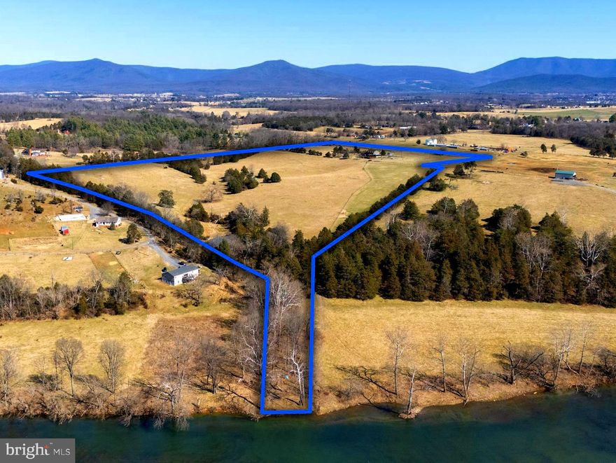 Riverfront dream come true in the Shenandoah Valley! 37+ acres of cross fenced pasture land fronting on the south fork of the Shenandoah River, completed by a fully renovated 4 bedroom, two and a half bathroom home with exquisite outdoor spaces.  Refined modern updates, elegant design, and numerous outdoor living areas make this home truly one-of-a-kind.  As you enter the home after driving up the private, paved driveway you are greeted by a warm inviting feel from the custom stone fireplace and windows which provide mountain and pasture views in every direction.  The luxurious amenities continue into the fully renovated kitchen, complete with stainless steel appliances, solid wood cabinets, quartz countertops, and a pantry.  The dining room contains a beverage refrigerator / serving area and can easily accommodate a large dining table, making it perfect for entertaining.  The two separate living areas on the main level seamlessly blend indoor comfort with outdoor living.  The fireplace, with its gas logs, is the perfect place to read a book by the warm fire and enjoy views of Kennedy’s Peak in the nearby George Washington National Forest.  Additional amenities on the main level include a half bathroom, office space, and numerous access points to the property’s outdoor living areas.  As you continue upstairs you will find four expansive bedrooms with new carpet, a primary suite with a walk-in shower, and exceptional views from every window.  An elevated patio with panoramic mountain and valley views is also accessed from the second level.  The HVAC system for the second level has recently been replaced. The two-car attached garage and additional separate shed provide ample space for all your storage needs.  Outside you will find a truly one-of-a-kind outdoor retreat featuring a front patio, decks, a six-person hot tub, screened-in porch, pergola, large stone fire pit and even an outdoor shower!  The pasture and mountain views from the outdoor spaces showcase the stunning beauty of the surrounding area and truly take your breath away.  The sunrise and sunset views from the rear deck appear like a colorful painting across the panoramic Massanutten and Appalachian mountain ranges.  At night stargazing in the clear skies above is a dream come true. The 37+ acres on which the home is located is fully fenced / cross fenced and contains a stream, pond, and frontage on the Shenandoah River.  You can easily launch kayaks, canoes, and tubes from the property and float for miles on the river.  Campfires and fishing provide the outdoor enthusiast with everything one could want. Located just minutes from downtown Luray, the Shenandoah National Park, and George Washington National Forest, this home with its 37+ acres offers easy access to hiking, biking, local shops, restaurants, and so much more! Do not miss out on this incredible opportunity — schedule your showing today!