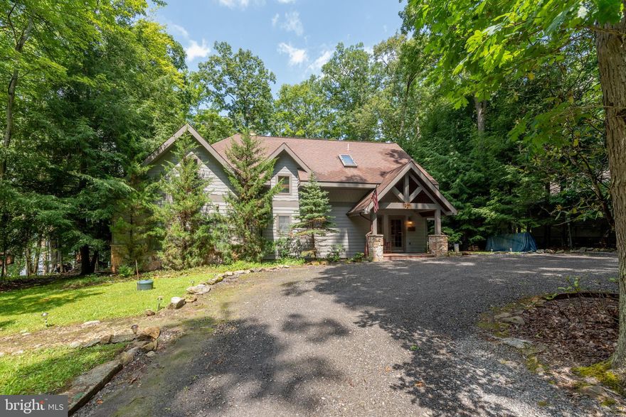 The sought after Lake Shore Drive Lakefront! This charming lakefront home has everything you would want in your Deep Creek Lake escape. The warmth of wood hugs you the minute you step in the door.  The beautiful, spacious living room boasts a wood cathedral ceiling, a wall of glass and a stone fireplace sets off the room. A spacious loft overlooking the living room adds to the charm. The family room is off of the kitchen with another stone fireplace! The charming kitchen has a large eat at bar with granite countertops and room for more than one chef.  Dining area is off of the kitchen/family room with windows across the back.  The Primary Bedroom has a private bath with a large tiled shower.  A second main level bedroom with a bath is located off of the family room. Upstairs are two charming, spacious  bedrooms, and a full bath and a half bath that opens to the tub shower area.  The deck area spans the home with a wonderful hot tub, hammock and firepit area. The lakefront is gorgeous with a recently expanded Type A dock! The views are nothing short of breathtaking!  A second firepit area and canoe rack completes the picture!  When you hear,  "Location Location Location"....this is it! Located just minutes from the Ski slopes, movie theatre and shopping. Schedule your appointment and end your search!