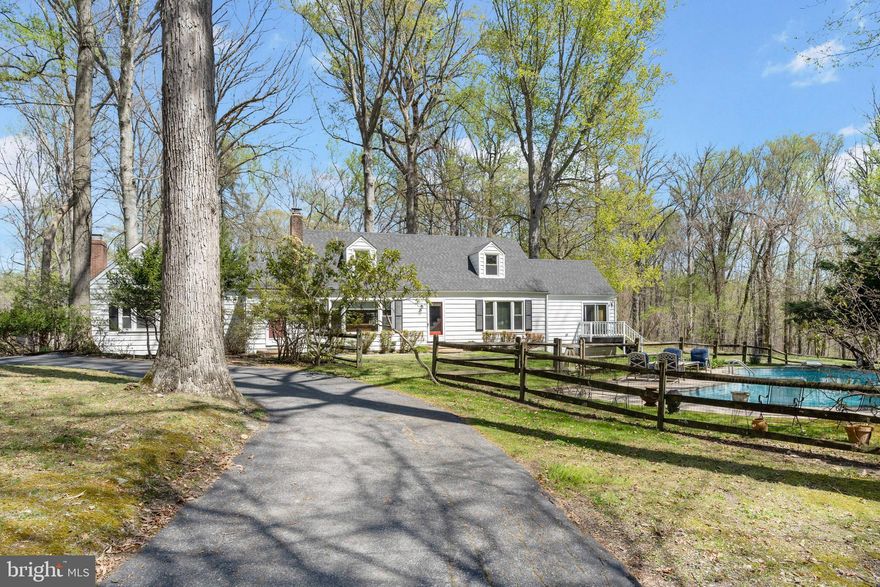 Welcome to this magnificent custom designed home with over 3,000 sq. ft, of living space in a serene setting  on almost an acre of land. This home is full of character and is perfect for anyone who loves to entertain or simply enjoys spacious living. Sunlight streams in through the many picturesque windows throughout the day across the main level’s wood floors and features two  brick wood burning fireplaces in each the formal living room, and the spacious family room with built in wet bar creating the perfect ambiance for those cozy evenings at home.  A great home for entertaining with a gourmet kitchen where there is ample room to prepare and cook meals and host family and friends between the eat in kitchen and dining room. The main level has 2 bedrooms, the Primary’s suite features outside access to a small deck, 4 spacious closets, long make-up vanity with sink,  an ensuite bathroom with tile and glass shower and stacked laundry closet, and a second bedroom and full hall bathroom.  Upstairs are 2 more bedrooms that are full of character with carpeting, vaulted ceilings, and a full bathroom with custom rain shower. The fully finished lower level has ceramic tile flooring and is a great space to make your own with a room for an office or den, another full bathroom, and second washer and dryer.   Enjoy summers outside swimming in your in-ground pool in your spacious yard where  you can grow your own vegetables and fruits in the greenhouse.  The long private driveway provides ample parking for you and your guests.  Easy access to 695 and 83, and short drives to all the hospitals from Towson to Baltimore City.  Many nearby shops, restaurants, and parks.  Don't miss out on the opportunity to call this stunning property your forever home. Schedule your tour today!