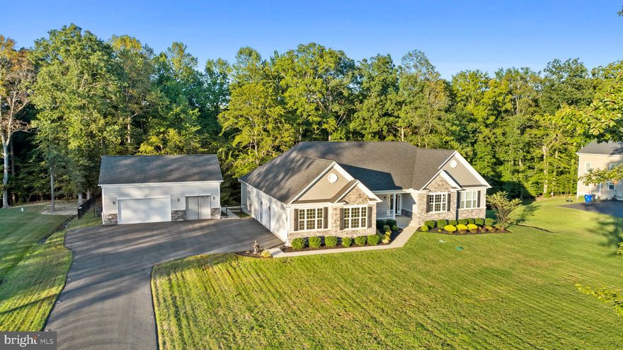 Welcome Home!  This stunning 4 bedroom, 3.5 bath Rambler with a finished basement has it all.  From the moment you pull in the driveway you will notice the pristine yard with an irrigation system in the front and back yard, amazing  exterior house lighting package to include landscape and downlights on front, sides and rear of house and detached garage, a total of 6 garage space and plenty of parking with the widened driveway. Then you enter the home and see the luxury vinyl plank throughout the main level, formal dining room, open kitchen that leads to the sunroom on one side and family room on the other side.  Imagine beginning and ending your day with either sitting in this gorgeous sunroom and looking outside or if you enjoy the fresh air, just step outside onto the deck that is surrounded by mature, beautiful trees and completely fenced in.  The family room has a gas fireplace and coffered ceiling and off the kitchen of your dream with QBHI's Grand kitchen, double wall ovens, gas cooktop and specialty hood, backsplash, upgraded refrigerator with bottom freezer, kitchen Island and breakfast bar, backsplash, granite, plus large pantry! The large Owners suite has a cathedral ceiling, 2 walk in closets, and an on suite bath with HUGE soak in tub, separate vanities, plus a deluxe shower with upgraded tile.  Mudroom/laundry room located right off of the garage with built in bench with cubbies for added storage.  The other side of the rambler features the other 2 bedrooms that share the hall bathroom with extra large vanity and a study with powder room.  All of this and now we move to the basement...  there is a large recreation room with access to the backyard, bedroom with walk in closet, full bathroom, plus unfinished area with utilities and storage area.  Lets not forget about the added bonus of the 3 car detached garage that is every car enthusiasts dream with many upgrades including a car lift, heat and AC!
This gorgeous home shows the pride of homeowners and with being just over 4 years old the sellers have made many improvements already. Including, Luxury Vinyl Plank flooring on main level
-Mitsubishi Split AC/Heat System installed in detached garage
-54” Aluminum fence with 10’ double gate and 5’ single gate
-Widened driveway three feet
-Kinetico water conditioning system with ultraviolet sterilizer
-Downspouts have been extended underground to rear property line 
-Generac 22kW standby generator
-Hunter Pro Irrigation front and rear yard 
-Metallic Epoxy flooring detached garage
-Complete exterior house lighting package to include landscape and downlights on front, sides and rear of house and detached garage
-Hardwired backyard flood lights
-Upgraded Chandeliers 
Do not wait, schedule your showing today!